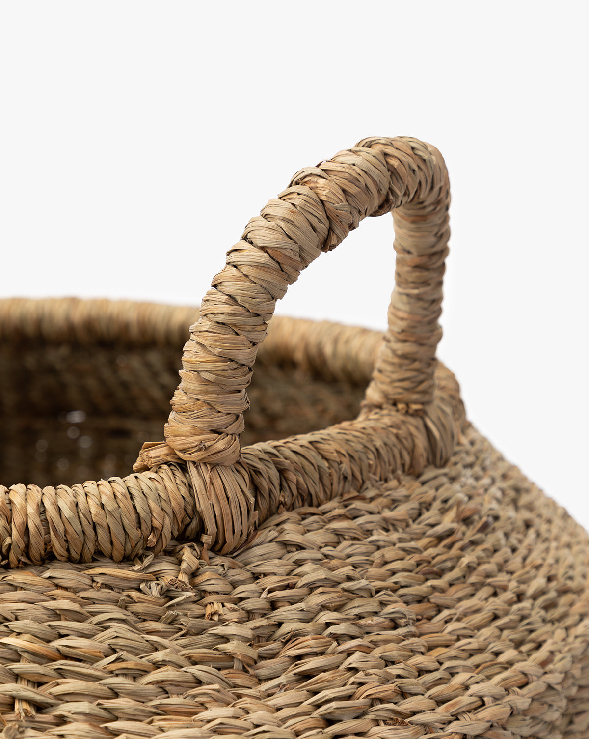 Close-up of the Liesl Basket, featuring intricate woven mendong grass and a sturdy upright handle, set against a plain white background, by Vendixs