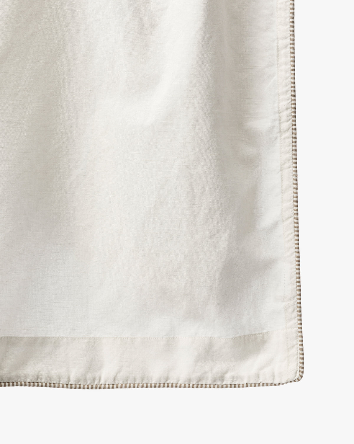 A close-up of the Lillian Shower Curtain with Striped Ties shows its light-colored linen fabric, smooth texture, and refined striped border, bringing an elegant touch to any bathroom décor, by Vendixs