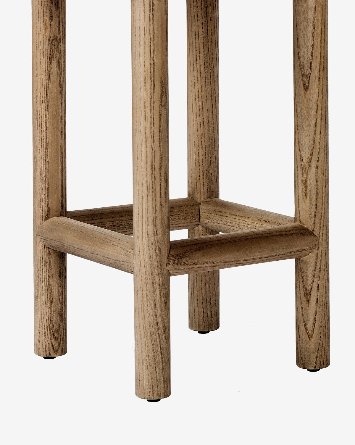 Close-up of the lower section of the Linus Stool, perfect for counters. This stool showcases four legs linked by a square support frame and offers a natural light wood finish with visible grain patterns by McGee & Co.