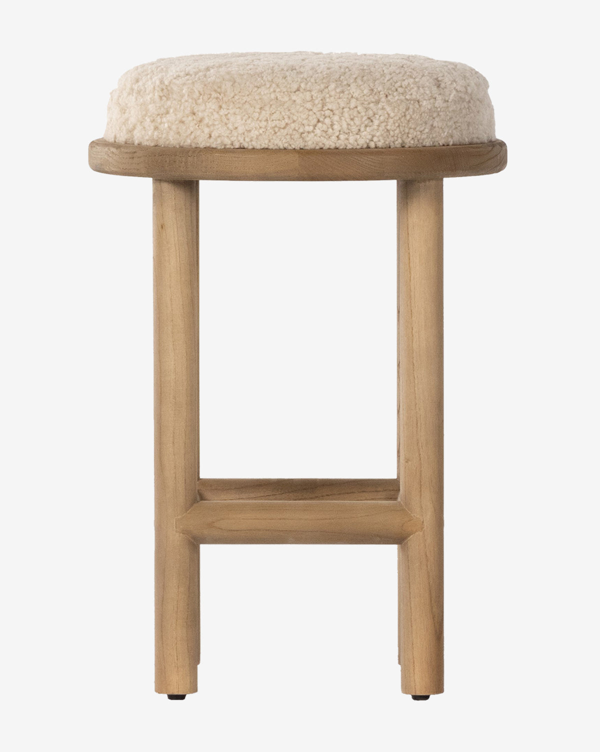 The Linus Stool pairs a minimalist look with three wooden legs and a round, beige shearling-upholstered seat—an ideal stylish accent for any white backdrop or modern counter seating, by McGee & Co.