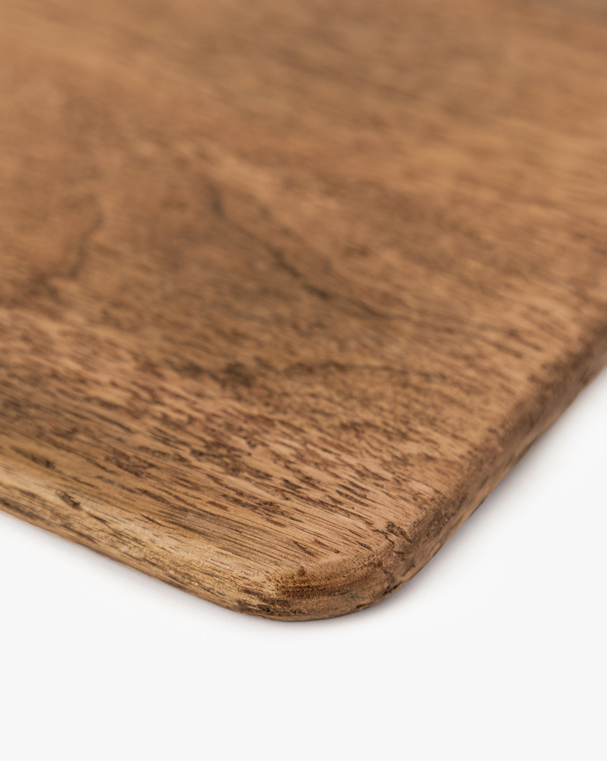 Close-up view of the Longfellow Breadboards corner, showcasing its smooth, rounded edge and natural mango wood grain against a white background—ideal for adding stylish flair to your kitchen decor, by Vendixs
