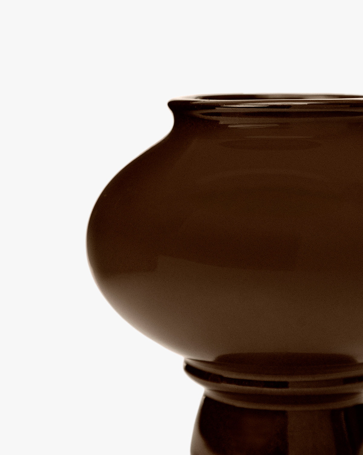 A close-up of the Louis Vase showcases its glossy dark brown ceramic finish, wide rounded body, and sculptural silhouette, all set against a plain white background, by McGee & Co.