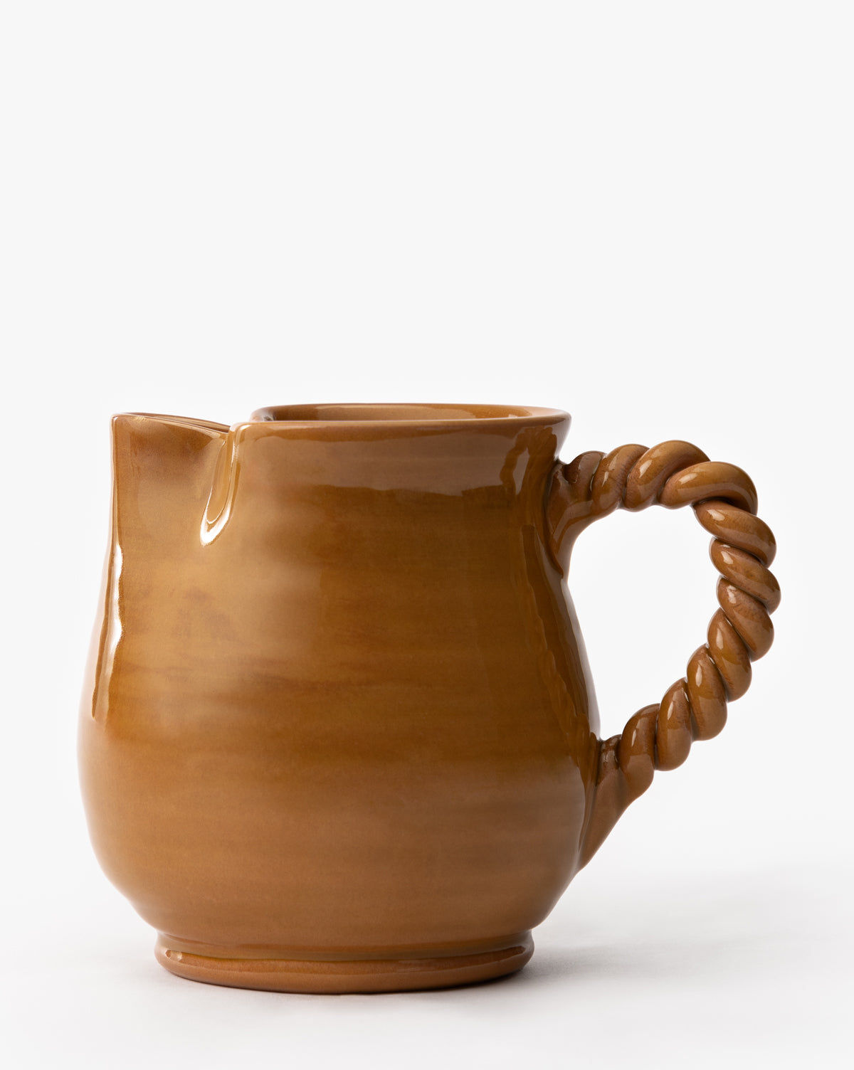 The Louise Jug is a brown terracotta vessel featuring a glossy earthenware glaze and a twisted, rope-style handle, set against a plain white background, by Vendixs