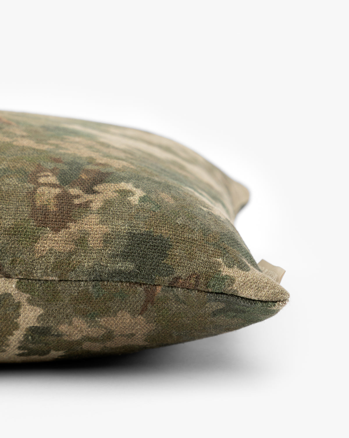 A close-up of the Lucetta Pillow Cover highlights its nature-inspired green and brown pattern, set against a plain white background by Vendixs