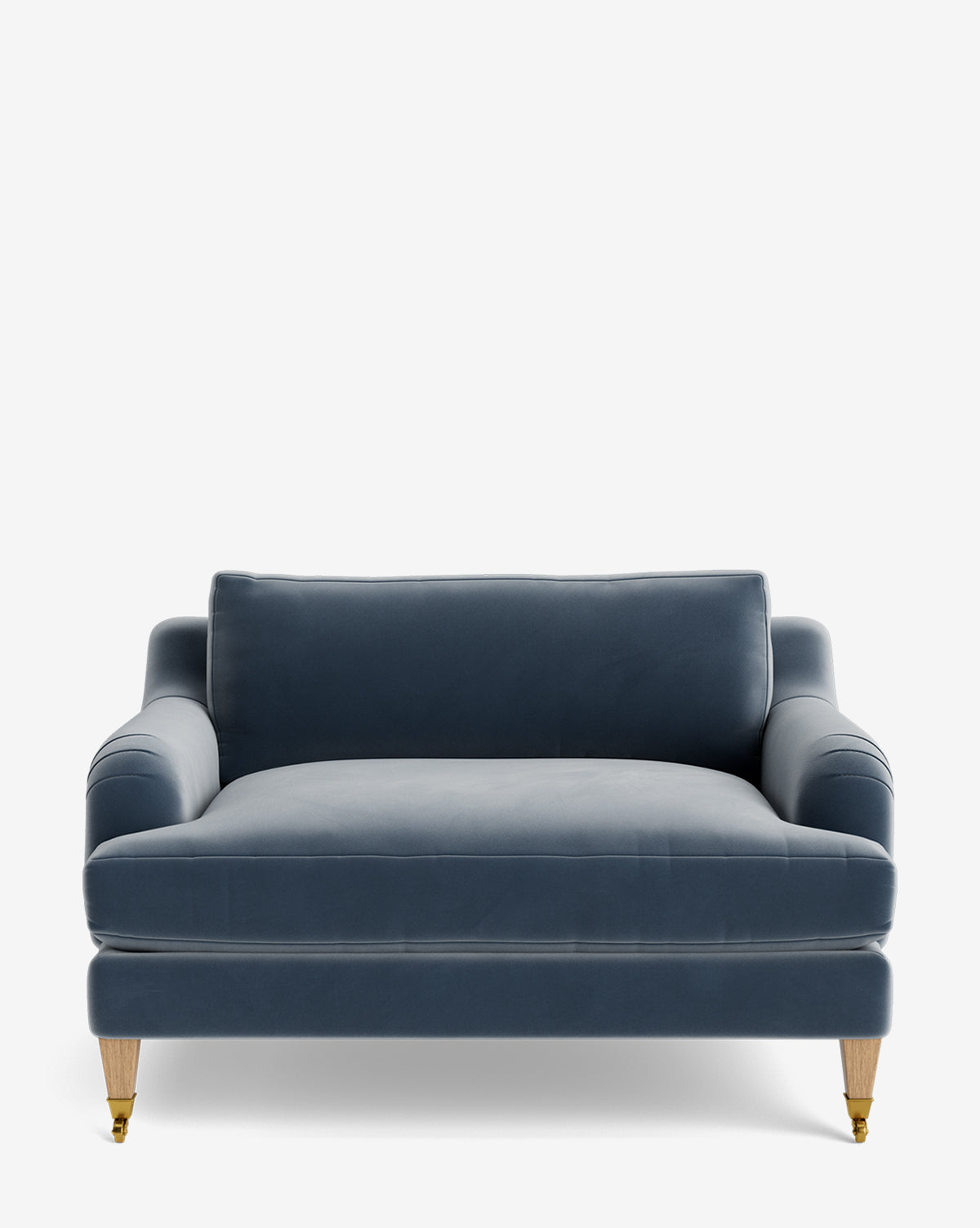The Lucille English Roll Arm Chair and a Half features blue velvet upholstery, a single down-wrapped seat cushion, matching back cushion, wooden legs, and brass front casters, shown against a white background by McGee & Co.