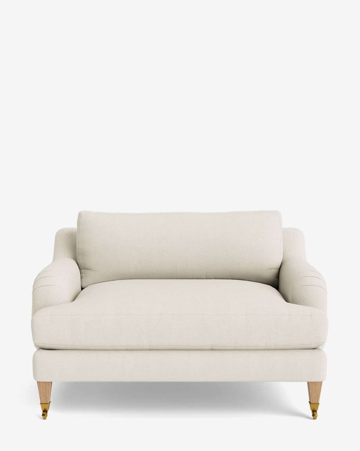 The Lucille English Roll Arm Chair and a Half is a cream-colored, upholstered seat with down-wrapped cushion, plush backrest, and wooden legs—two with brass casters—offering modern minimalism inspired by classic English design, by McGee & Co.