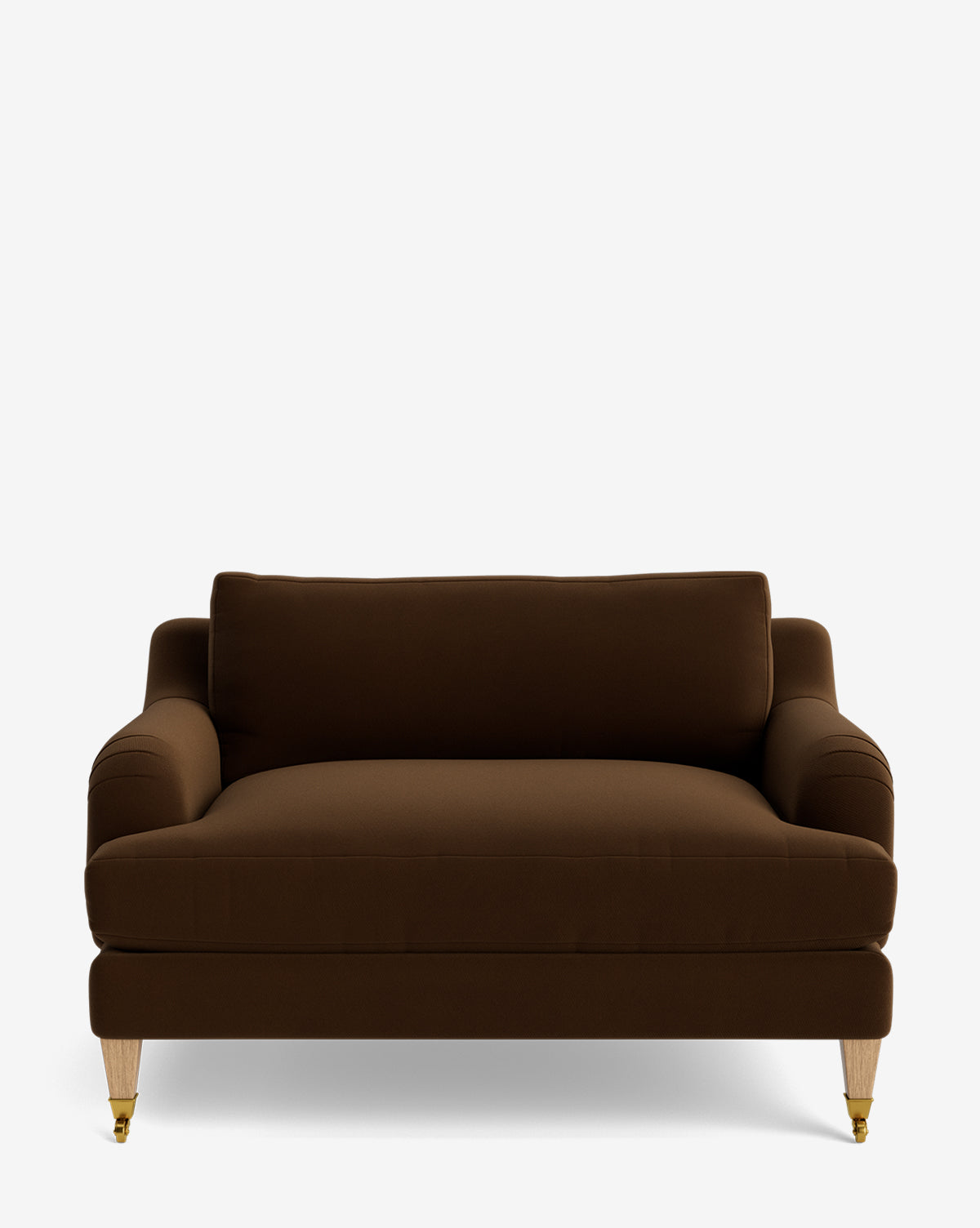 The Lucille English Roll Arm Chair and a Half features dark brown upholstery, English roll arms, a down-wrapped cushion, and four short legs—two with brass caster wheels in front and two plain back legs—shown on a white background by McGee & Co.