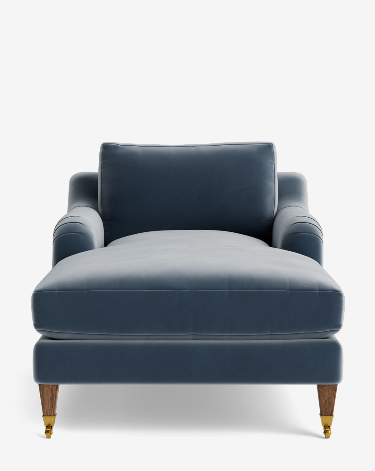 Front view of the Lucille English Roll Arm Lounge Chair in blue velvet, featuring a low, wide seat, down-wrapped cushion, padded backrest and armrests, plus wooden legs with brass casters on the front two legs, by McGee & Co.
