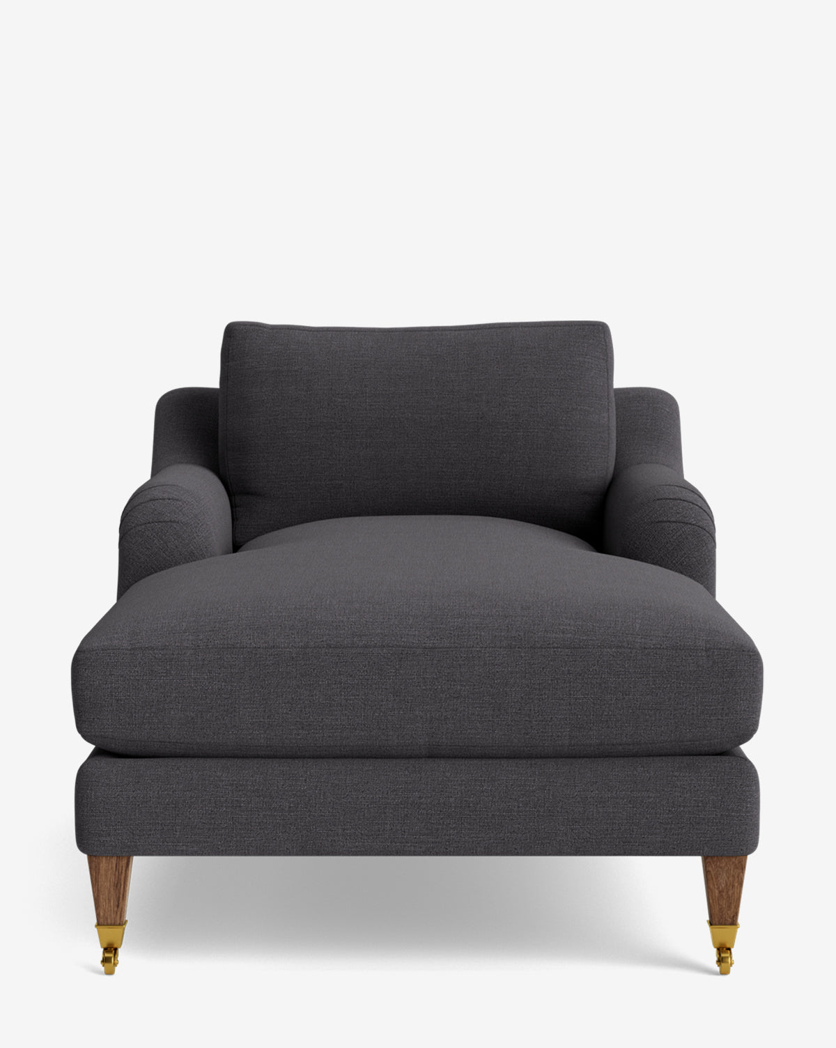 Front view of the Lucille English Roll Arm Lounge Chair, featuring modern dark gray upholstery, a wide down-wrapped cushion, low arms, and wooden legs with brass caster wheels on the front, by McGee & Co.