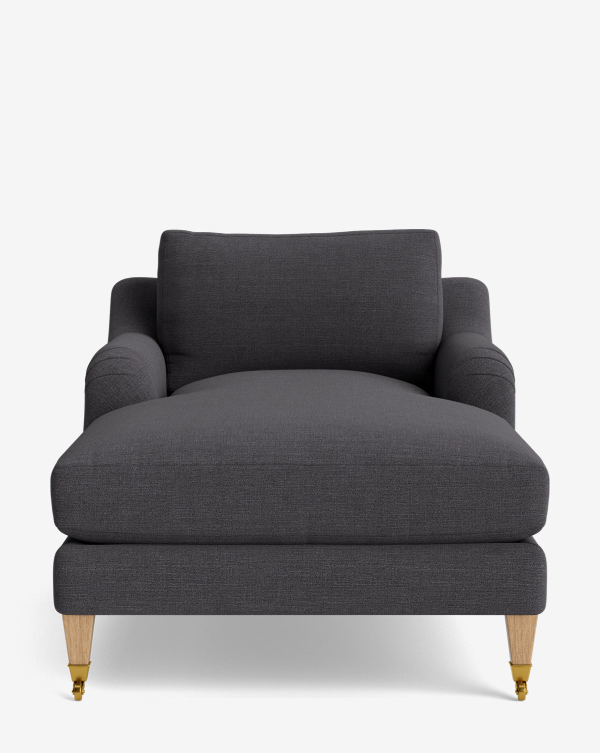 A front view of the Lucille English Roll Arm Chaise Lounge in modern dark gray with wooden legs—two with brass wheels—set against a white background. This customizable chaise features a plush, down-wrapped cushion for comfort, by McGee & Co.
