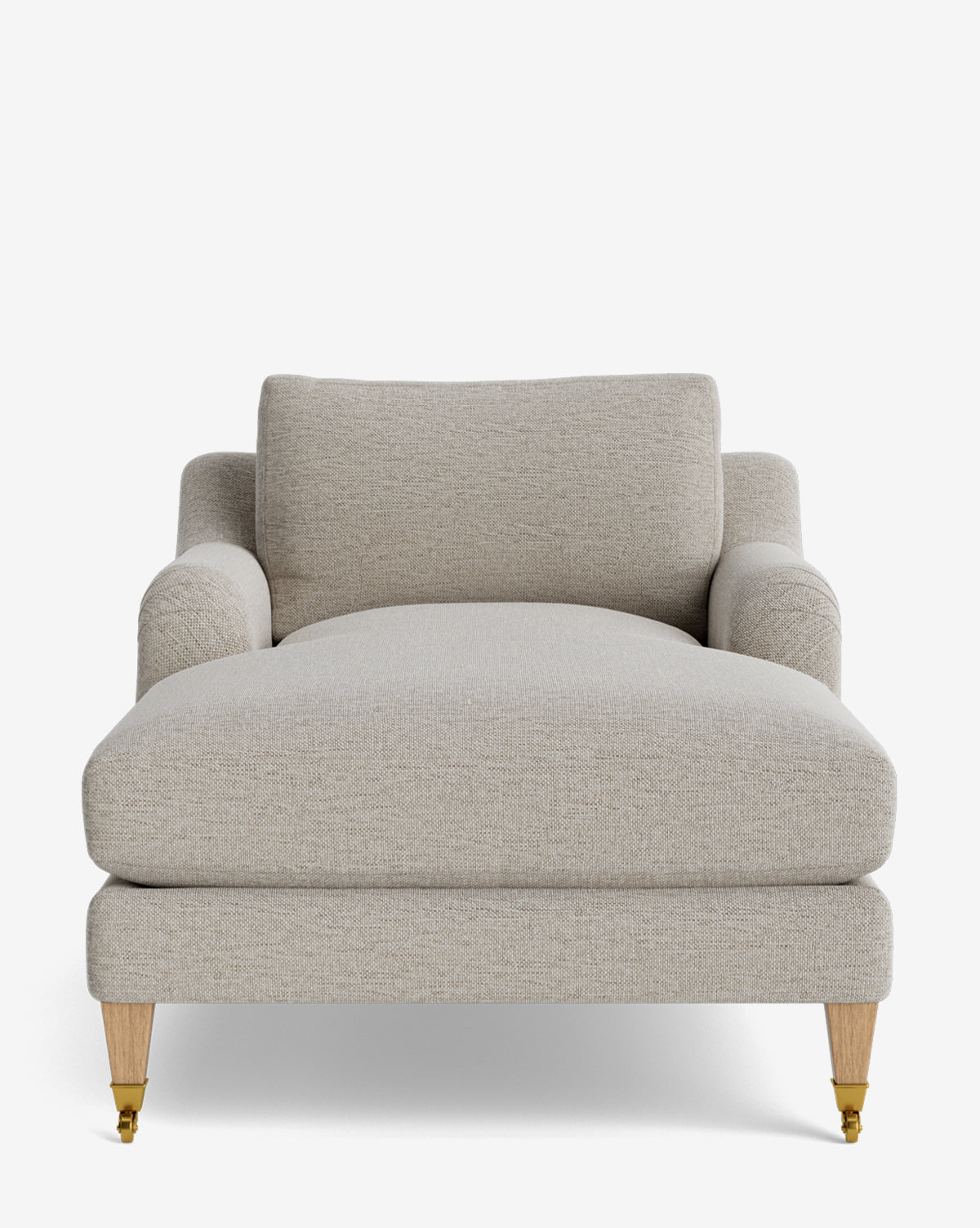 The Lucille English Roll Arm Chaise Lounge features light beige upholstery, a down-wrapped cushion, upholstered seat, backrest, and armrests, plus light wooden legs with brass front casters, shown against a plain white background by McGee & Co.
