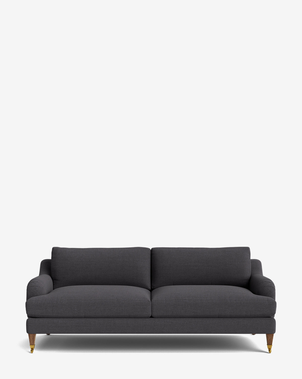 The Lucille English Roll Arm Sofa 78 features dark gray upholstery, two down-wrapped seat cushions, a low backrest, and wooden legs with brass casters, shown against a plain white background by Vendixs