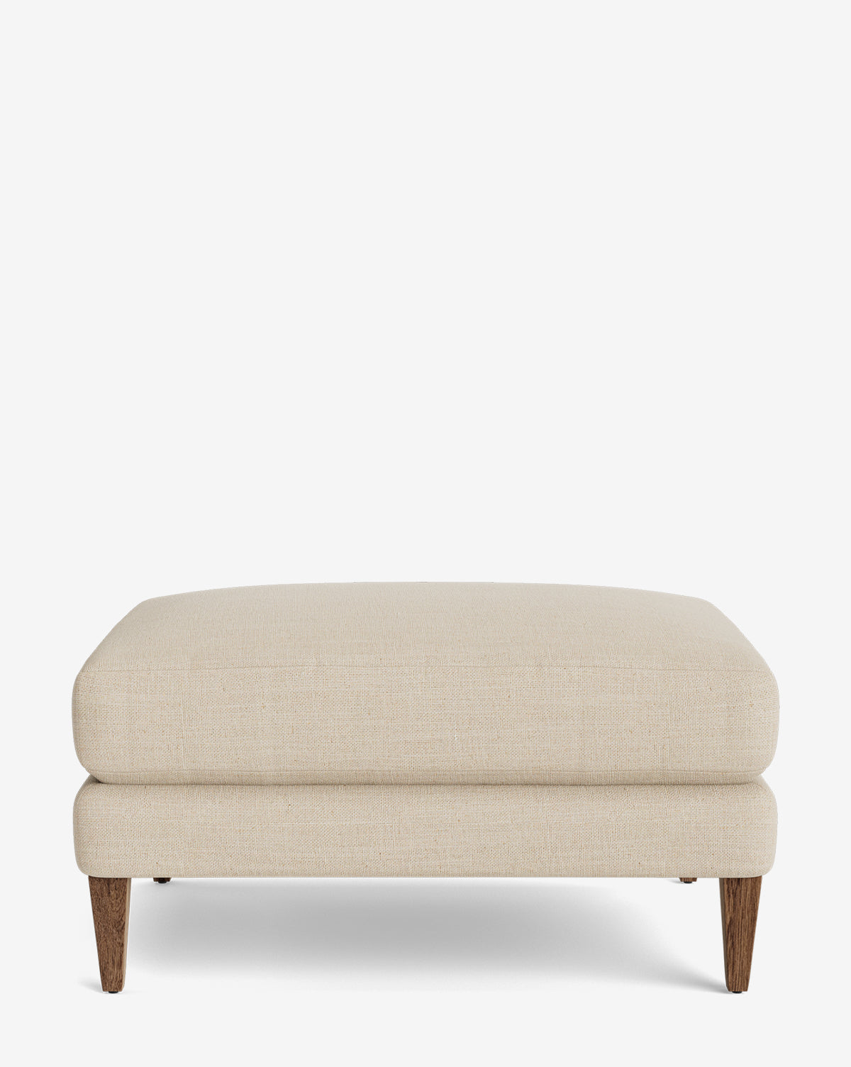 The Lucille Ottoman is a modern rectangular beige upholstered ottoman with wooden legs, displayed on a plain white background, by McGee & Co.