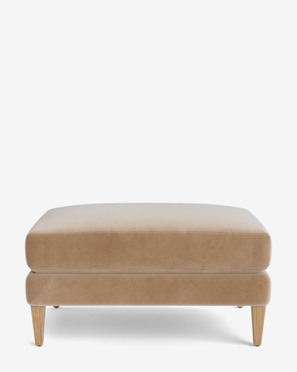The Lucille Ottoman is a modern, beige rectangular ottoman with smooth upholstery and four light wooden legs, viewed from the front on a white background, by McGee & Co.
