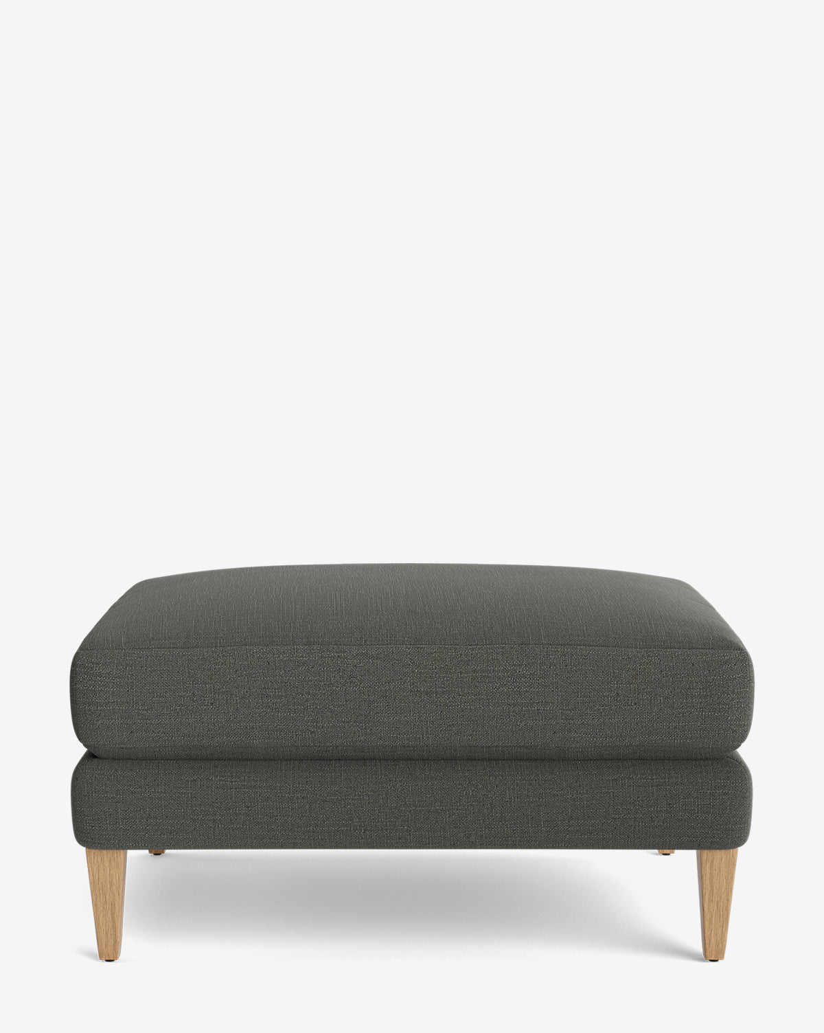 The Lucille Ottoman features a modern rectangular design with dark gray upholstery and wooden legs, displayed on a plain white background, by Vendixs