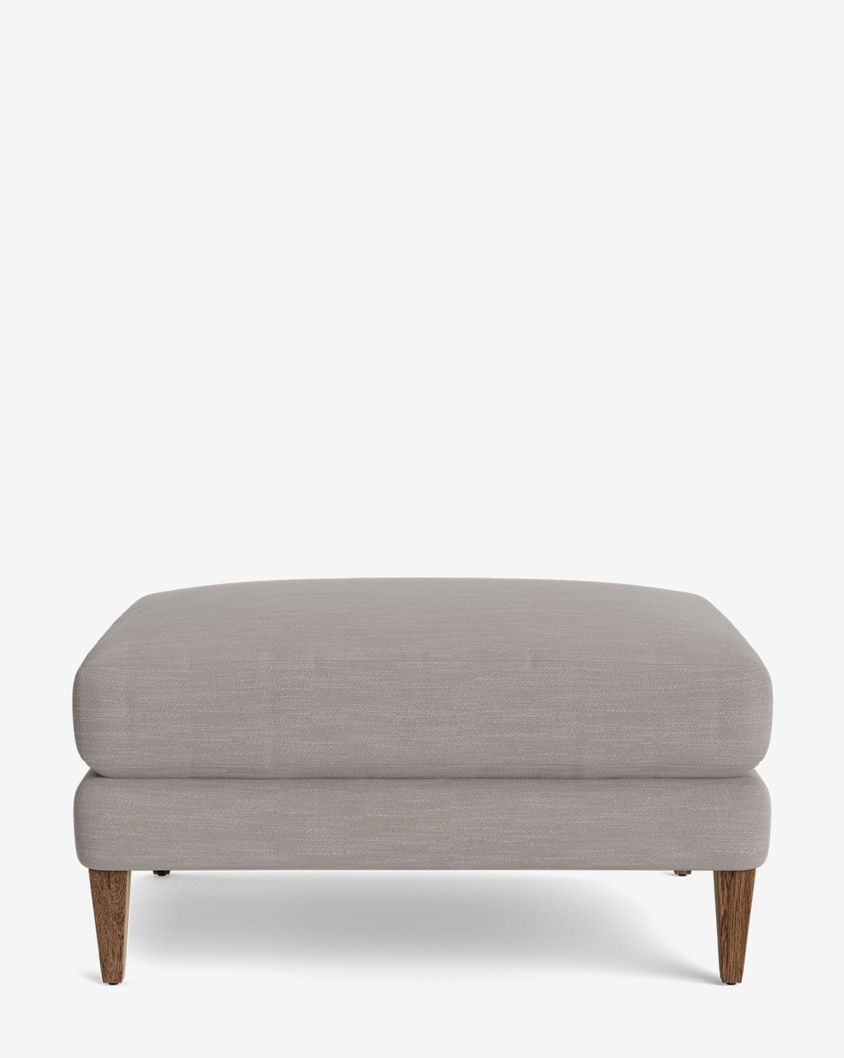 The Lucille Ottoman is a modern, rectangular ottoman in light gray upholstery with short wooden legs, shown against a plain white background, by Vendixs