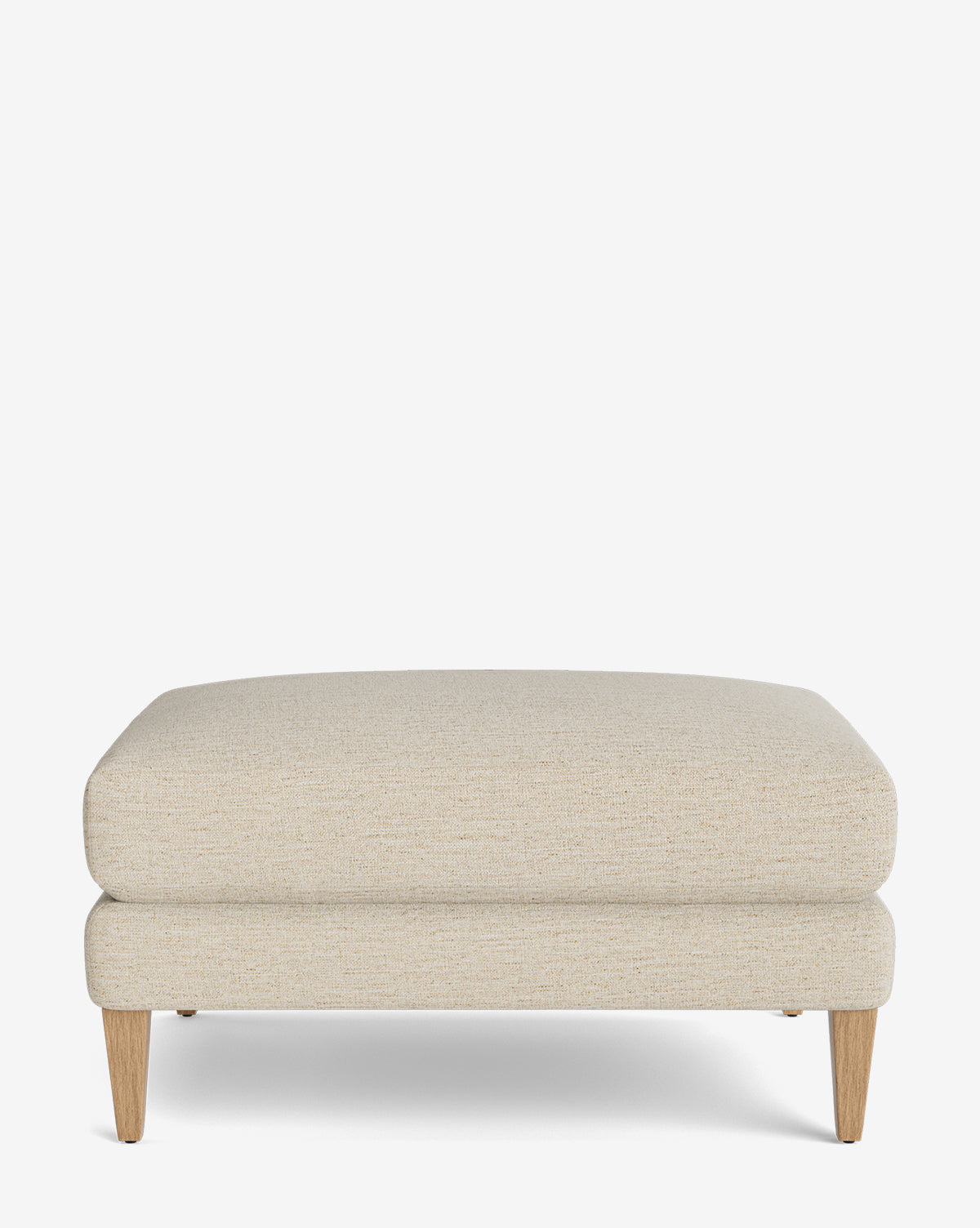 The Lucille Ottoman is a modern rectangular ottoman with beige upholstery and wooden legs, displayed on a plain white background, by McGee & Co.