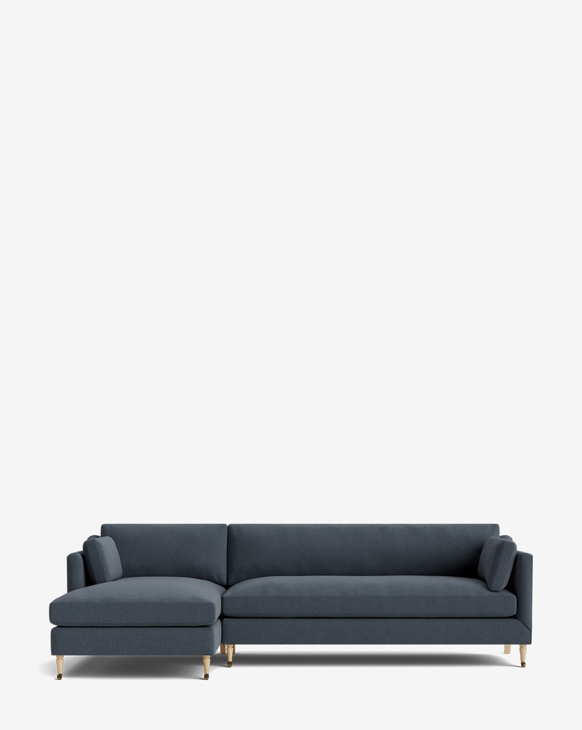 The Haverford Upholstered Left Chaise Sectional by Rowe Fine Furniture features dark blue fabric, gold legs, a left chaise, and two matching cylindrical pillows, shown on a plain white background. Vendixs