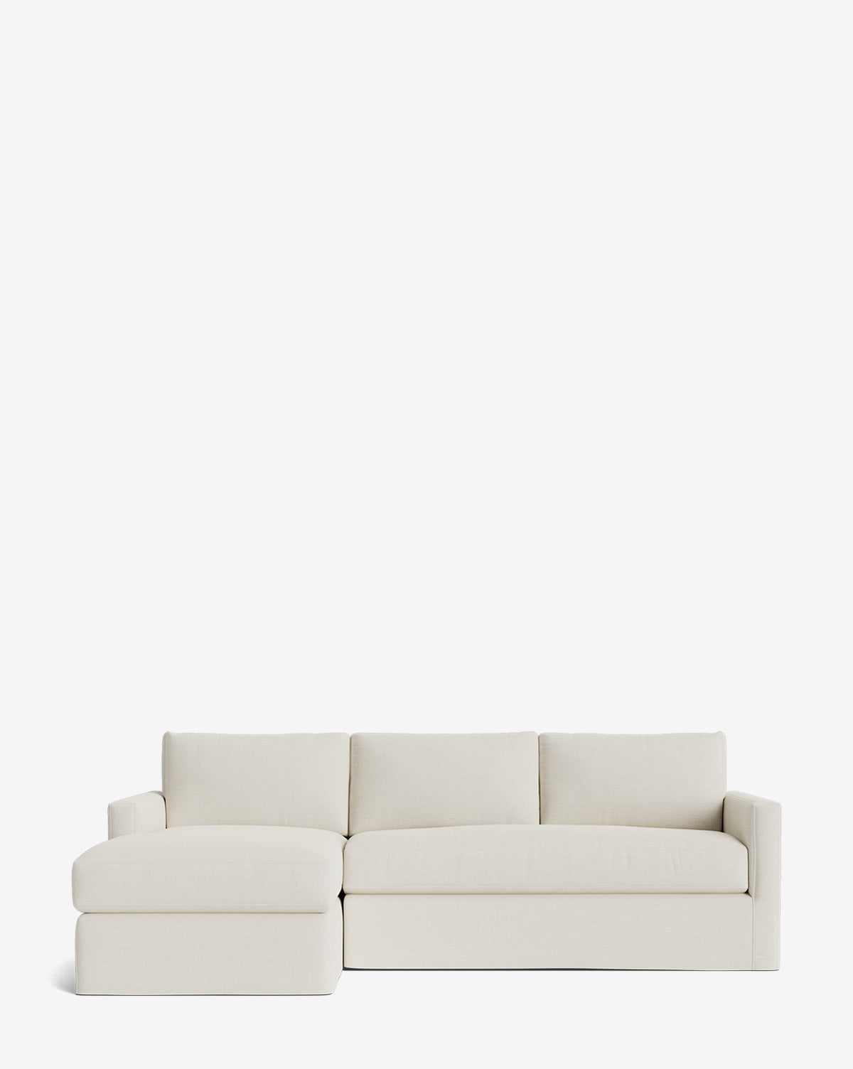 The Community Macy Slipcover Chaise Sectional 101 is a modern, light beige sofa with a left-facing chaise, clean lines, three seat cushions, and three back cushions, shown against a plain white background. Vendixs
