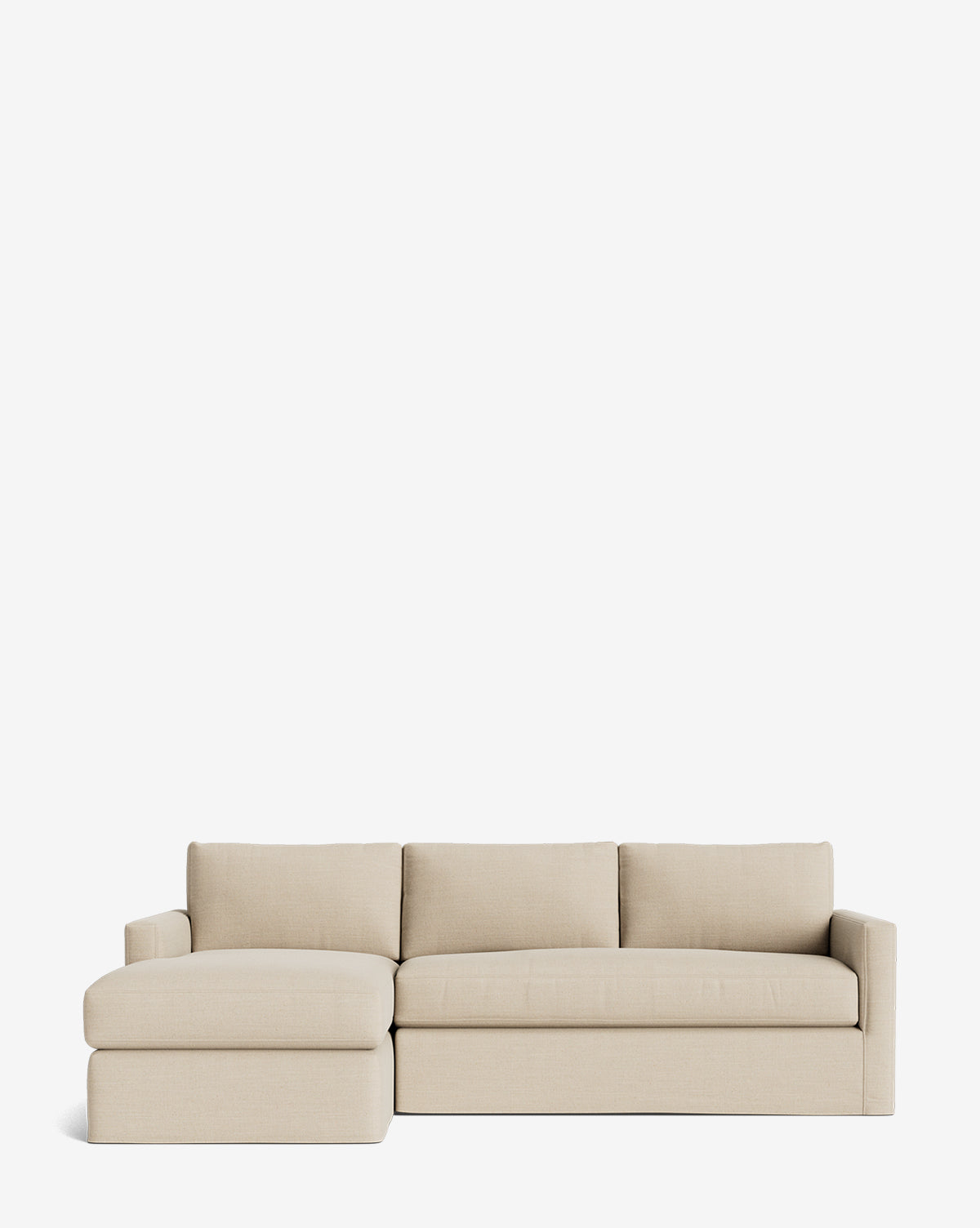 The Macy Slipcover Chaise Sectional 101 by Community features three seat and back cushions, a left-side chaise, and a deep-sectional design in beige, shown against a plain white background by Vendixs