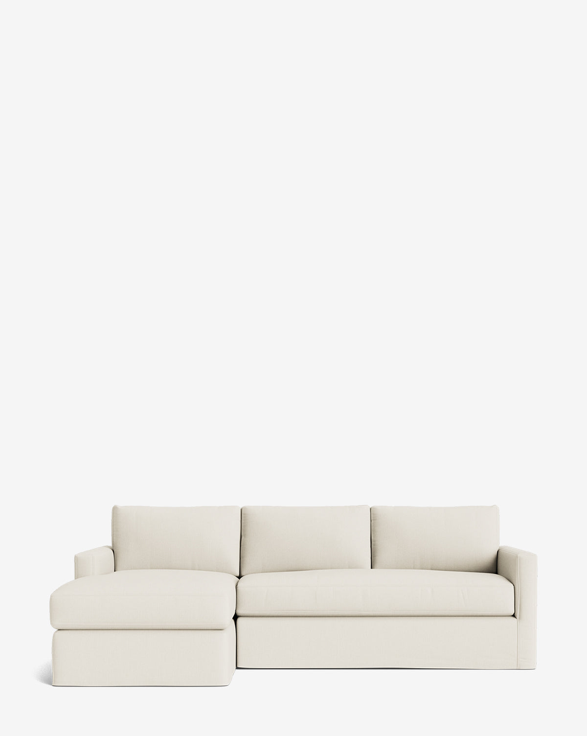 The Community Macy Slipcover Chaise Sectional 101 in light beige features clean lines, plush cushions, and a left-facing chaise lounge, set against a plain white background. Vendixs