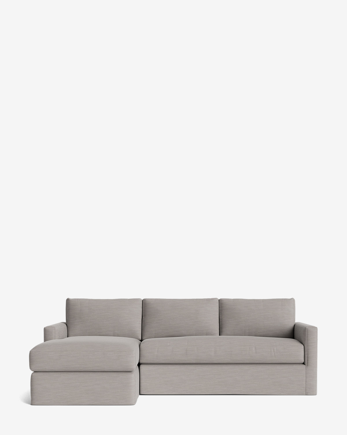 The Community Macy Slipcover Chaise Sectional 101 features a modern light gray design with three back cushions and a left-facing chaise lounge, highlighting its deep sectional look against a plain white background. Vendixs
