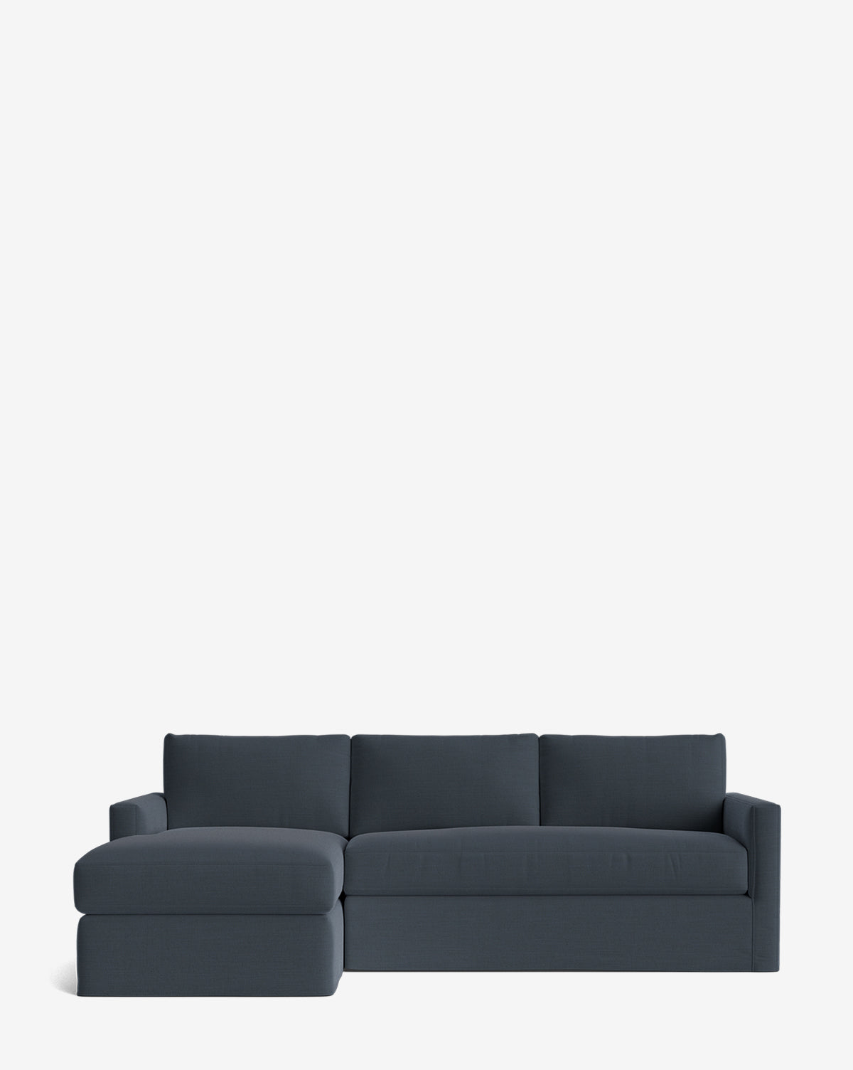 The Community Macy Slipcover Chaise Sectional 101 in dark blue features a deep design with three back cushions and a left-side chaise lounge, displayed against a plain white background. Vendixs