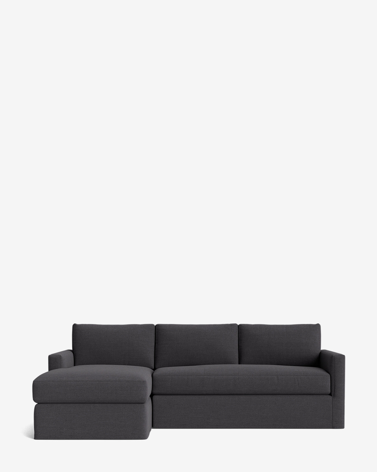 The Community Macy Slipcover Chaise Sectional 101 features a modern deep design in dark gray with three back cushions and a left-side chaise, shown against a plain white background. Vendixs