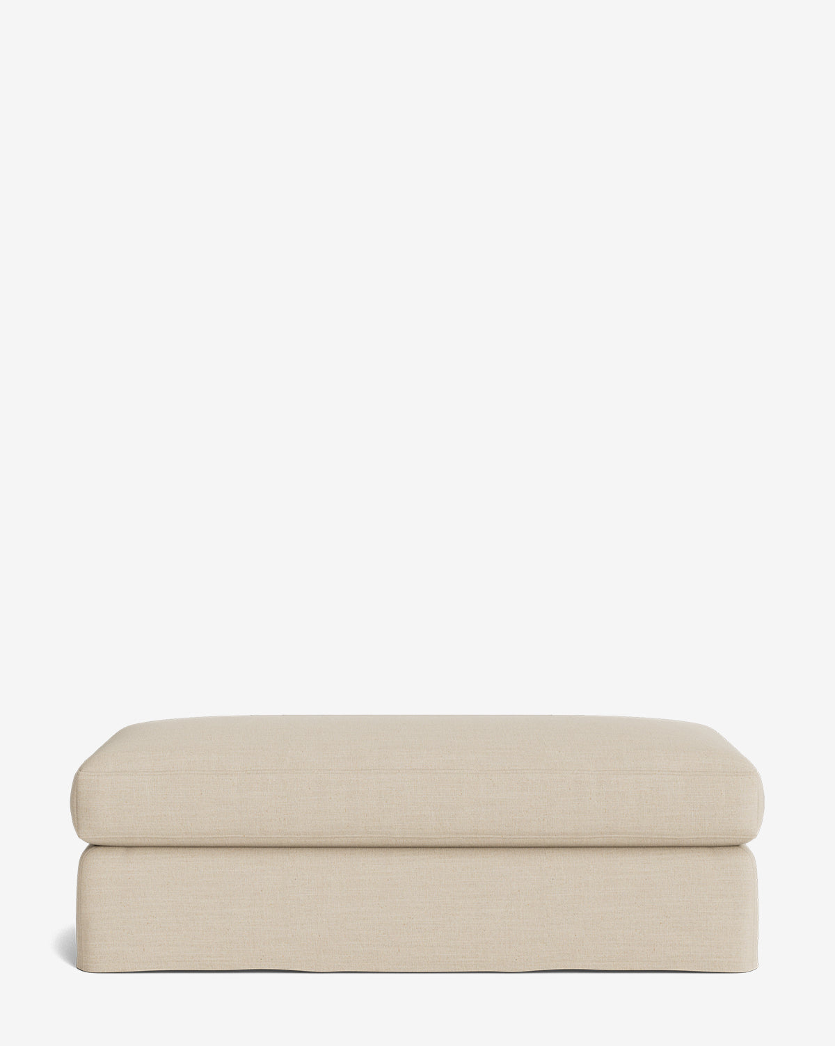 The Macy Slipcover Ottoman is a rectangular, beige ottoman with soft, rounded edges and a minimalistic design—ideal for living room furniture—shown on a plain white background by McGee & Co.