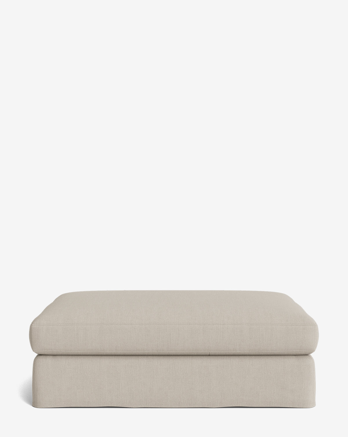 The Macy Slipcover Ottoman is a rectangular, light beige piece with rounded edges that adds versatility to your living room, shown against a plain white background by McGee & Co.