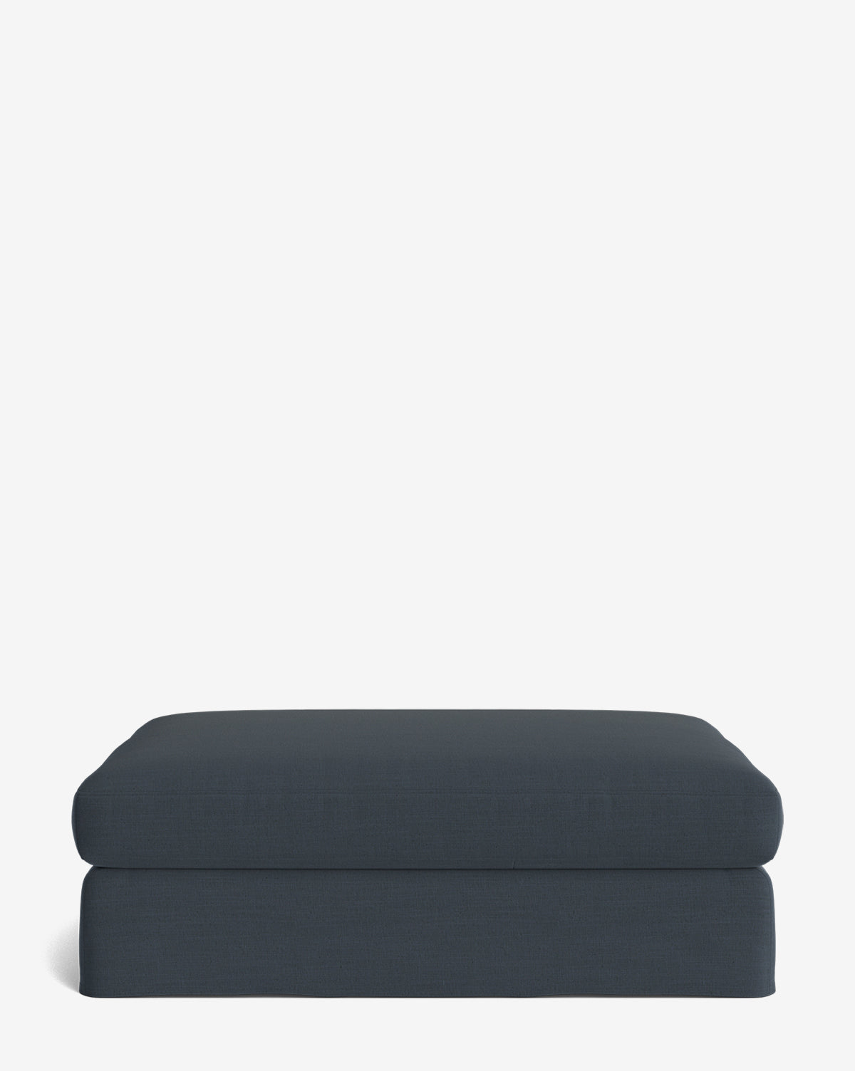 The Macy Slipcover Ottoman, a dark blue rectangle with soft, rounded edges and smooth fabric, sits on a plain white background. Its minimalist design is perfect for modern living room decor, by Vendixs