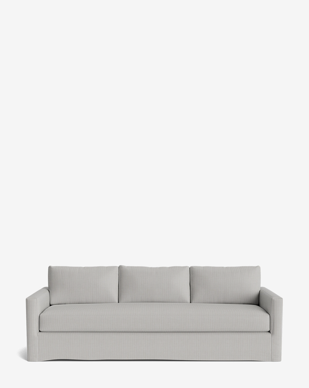 The Macy Slipcover Sofa (84-96) is a modern, light gray customizable sofa with straight arms and three back cushions. It features subtly ribbed upholstery and deep seating, shown against a plain white background, by McGee & Co.