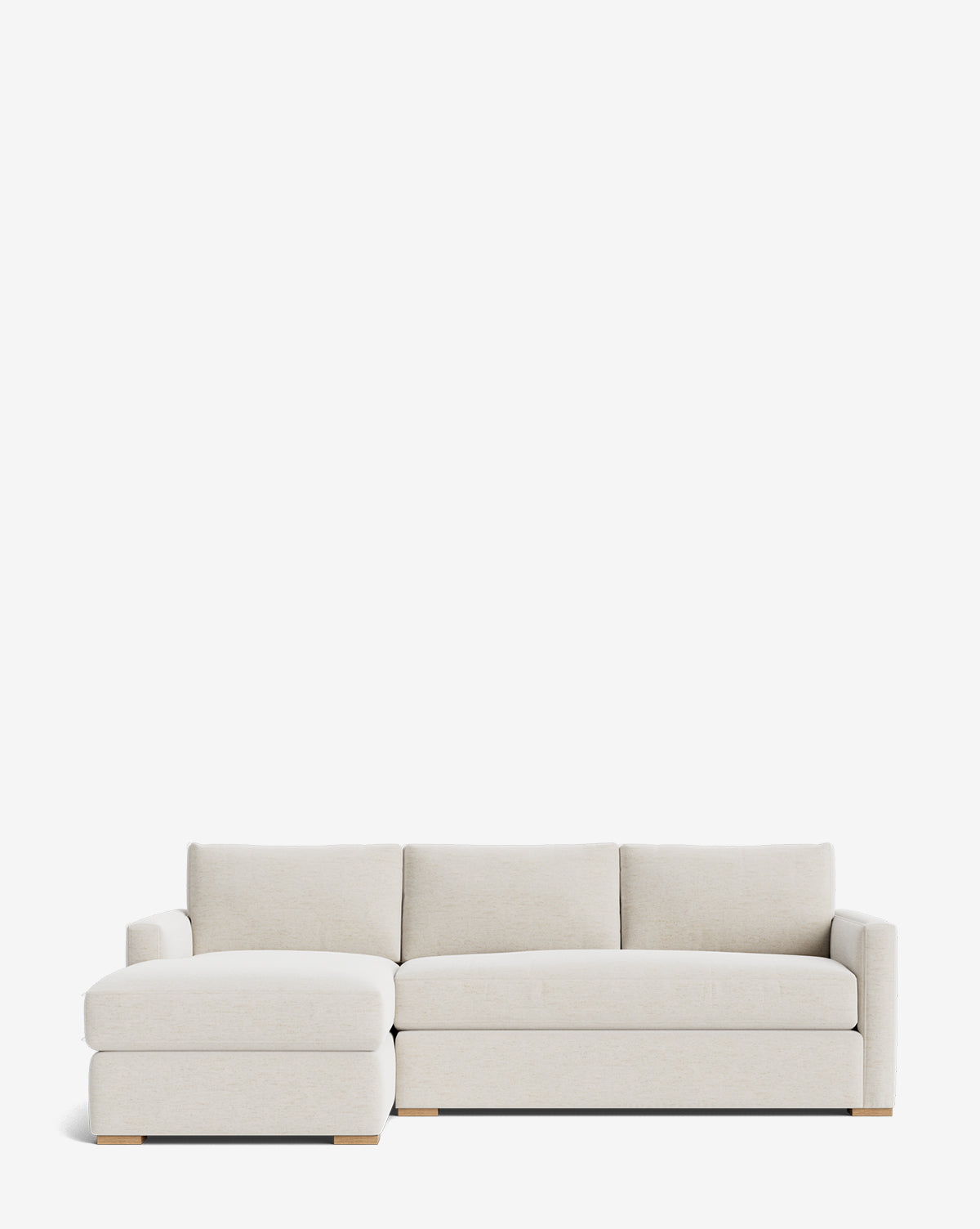 The Macy Upholstered Chaise Sectional 101 by Community is a modern, luxury light beige sofa with a left-facing chaise, low wooden legs, and plush cushions, shown against a plain white background. Vendixs