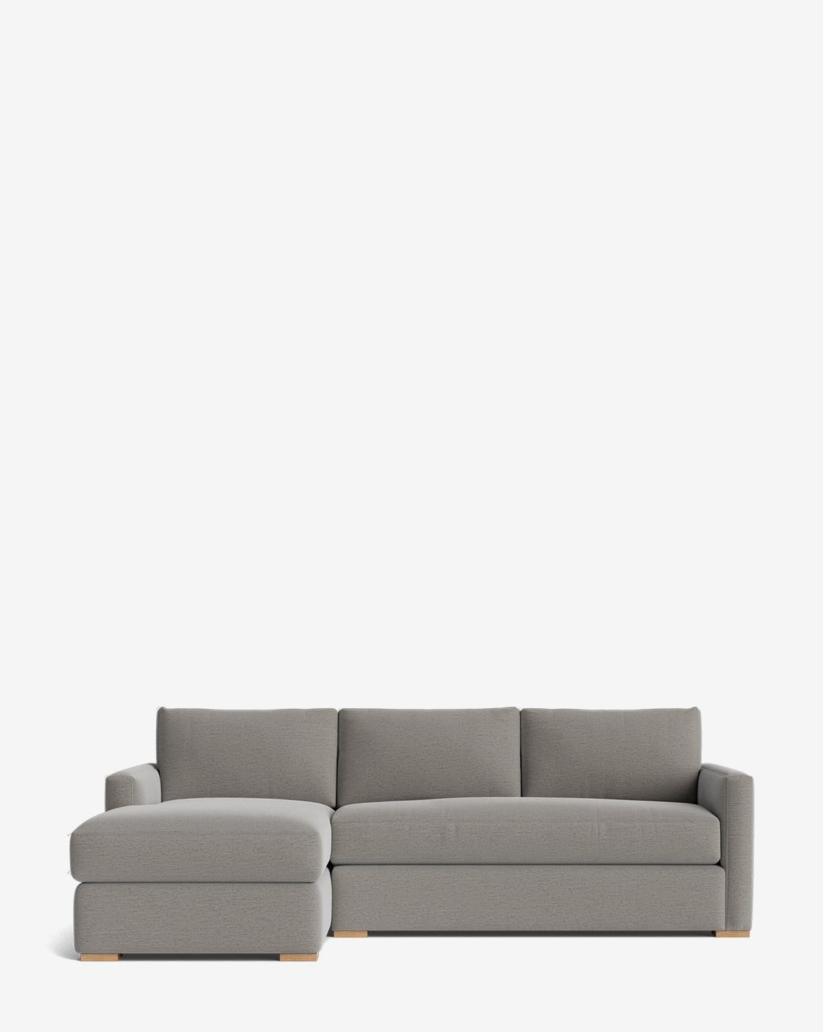 The Community Macy Upholstered Chaise Sectional 101, in modern gray with three back cushions, a left-side chaise lounge, and low wooden block feet, is shown against a plain white background, Vendixs