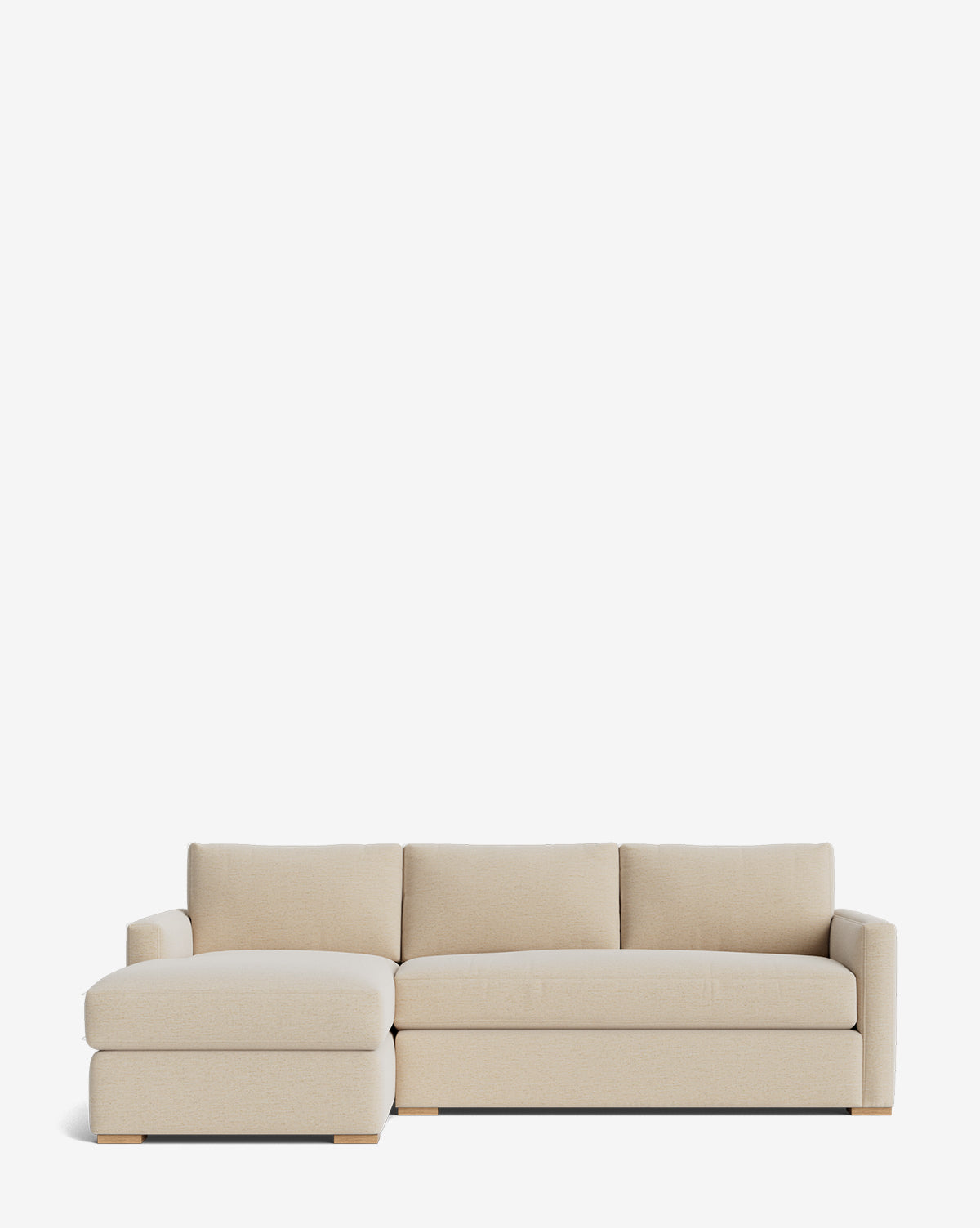 The Community Macy Upholstered Chaise Sectional 101 features beige fabric, clean lines, low wooden legs, a left-side chaise lounge, and three back cushions, shown against a plain white background. Vendixs