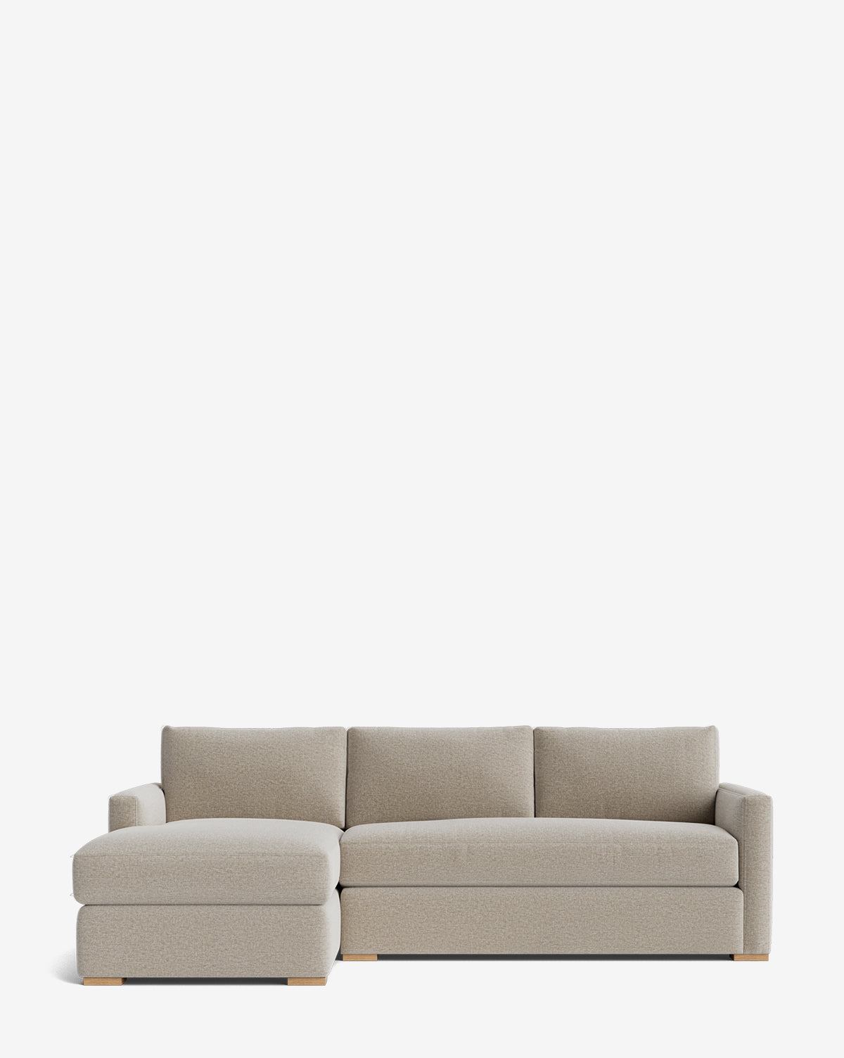 The Community Macy Upholstered Chaise Sectional 101 features a modern design with light gray fabric, clean lines, wooden block feet, three back cushions, a low profile, and a left-facing chaise lounge by Vendixs