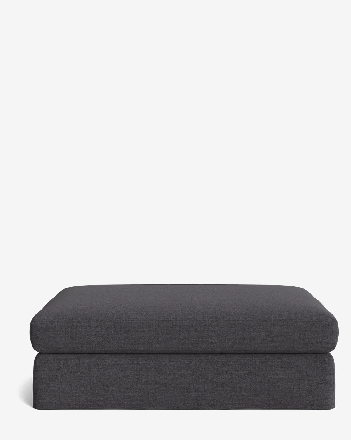 The Macy Slipcover Ottoman, shown in dark gray, sits against a plain white background. Its modern, simple design with clean lines and a soft cushioned top makes it a stylish, customizable choice for your living room, by Vendixs