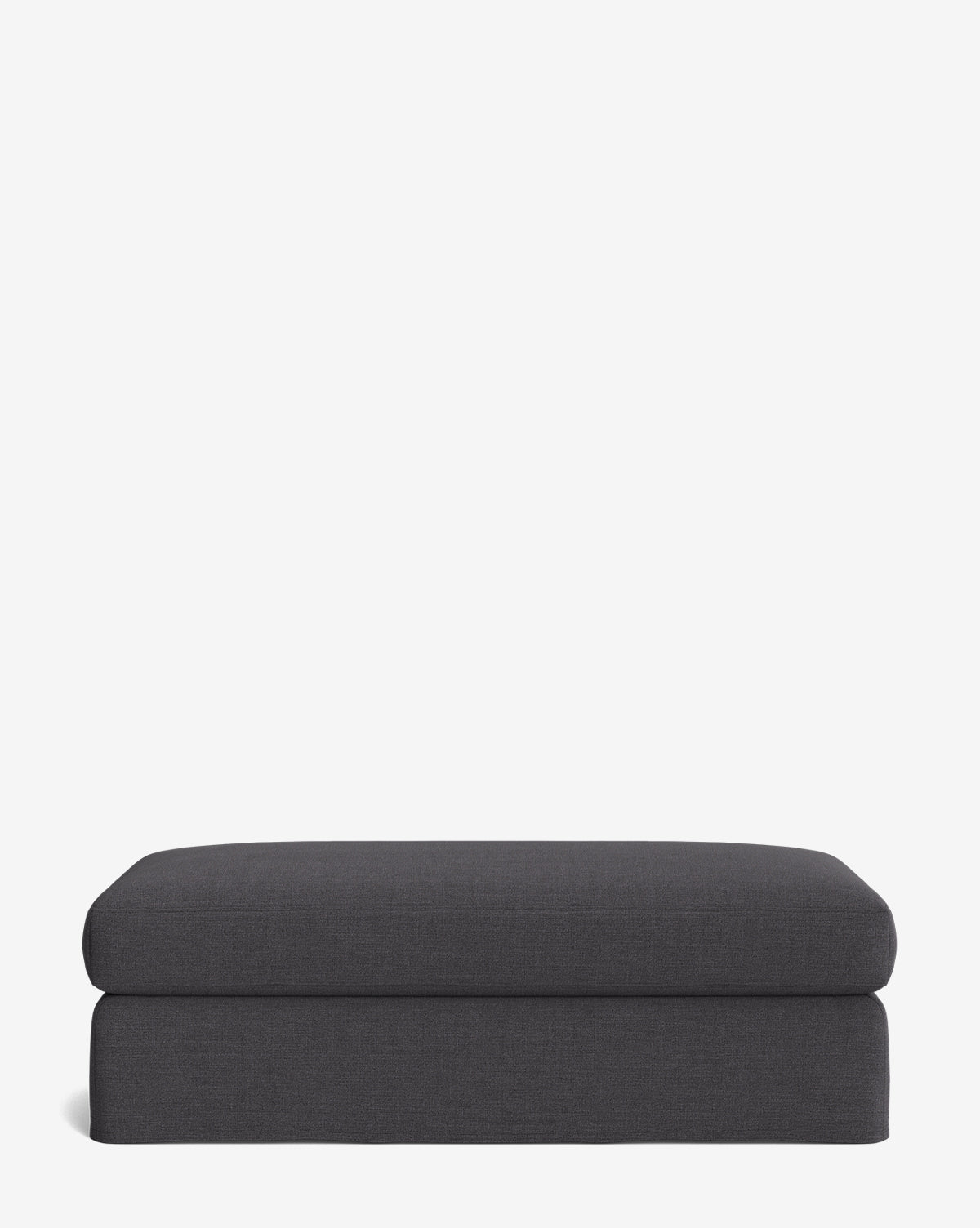 The Macy Slipcover Ottoman features a rectangular shape, dark gray upholstery, and clean, modern lines—an ideal customizable addition to your living room, shown here against a plain white background, by Vendixs