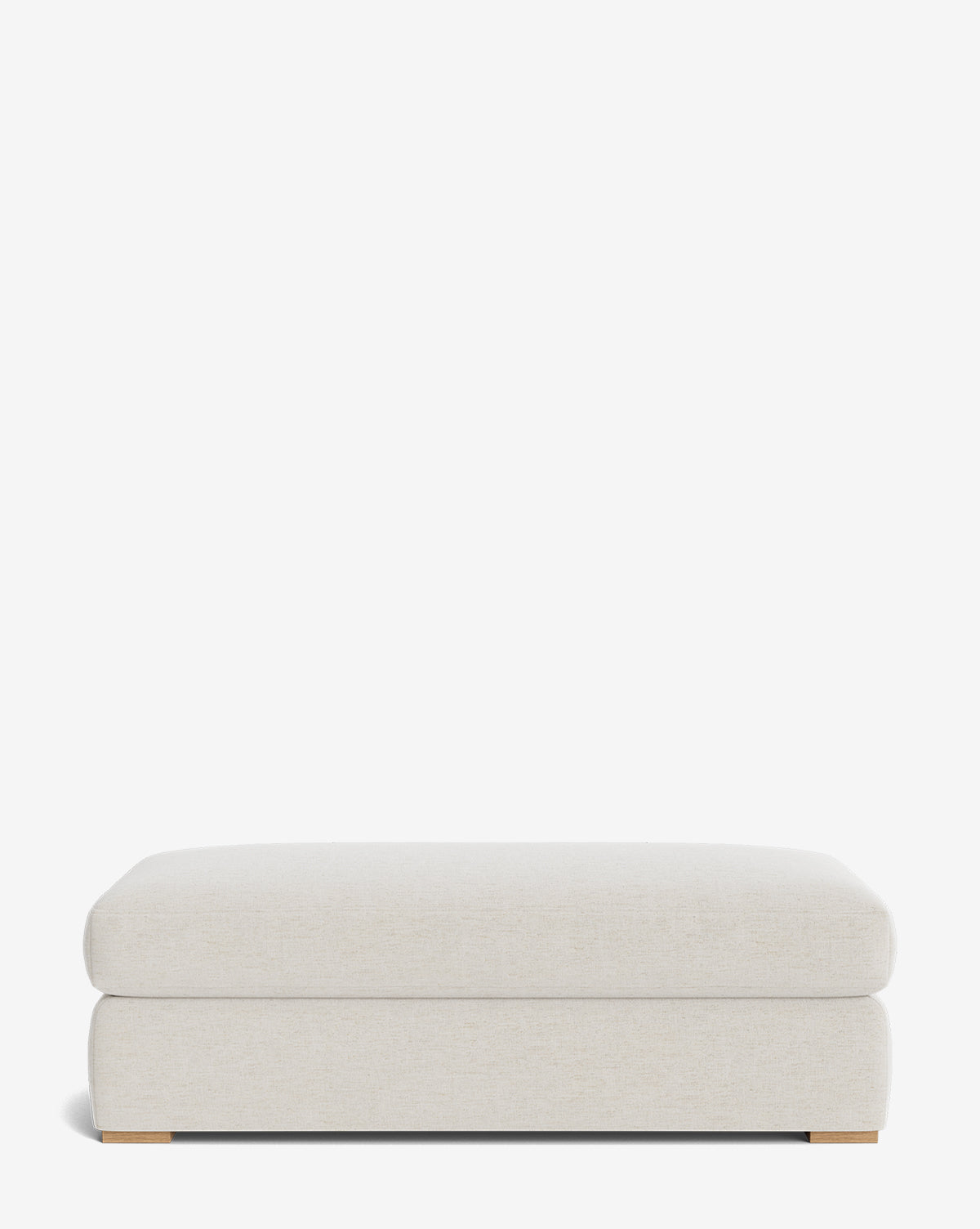The Macy Upholstered Ottoman is a large, rectangular, light beige piece with a modern design and low wooden feet, ideal as stylish living room furniture, shown against a plain white background by McGee & Co.