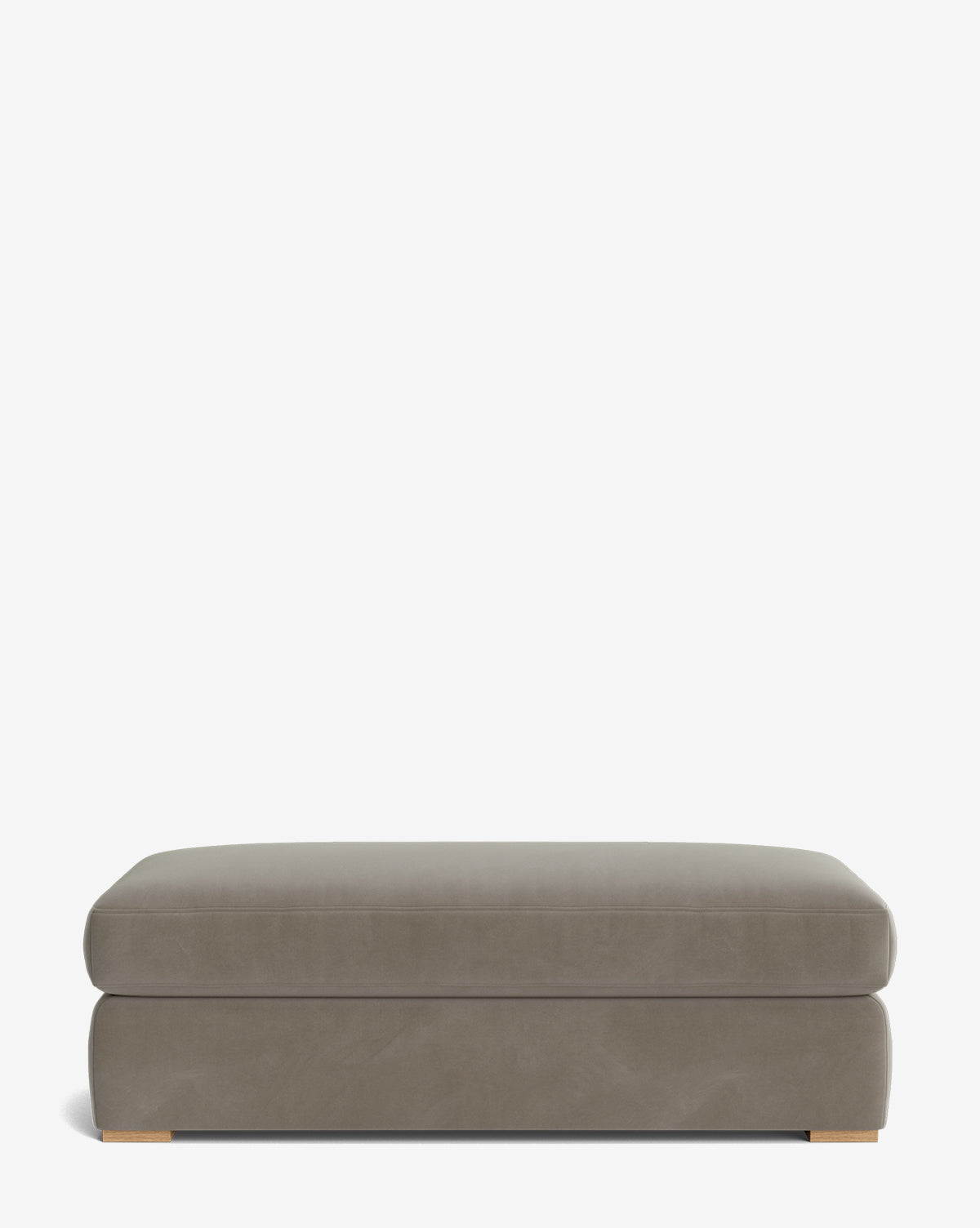 The Macy Upholstered Ottoman is a large, rectangular taupe piece with short wooden feet, offering versatile living room seating, by McGee & Co. Shown against a plain white background.