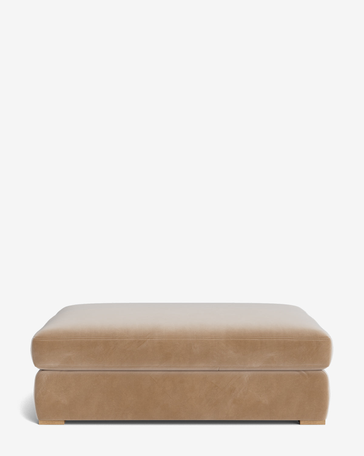 The Macy Upholstered Ottoman is a large, rectangular piece featuring a smooth, cushioned top and subtle wooden feet—perfect as versatile living room furniture—shown against a plain white background by McGee & Co.