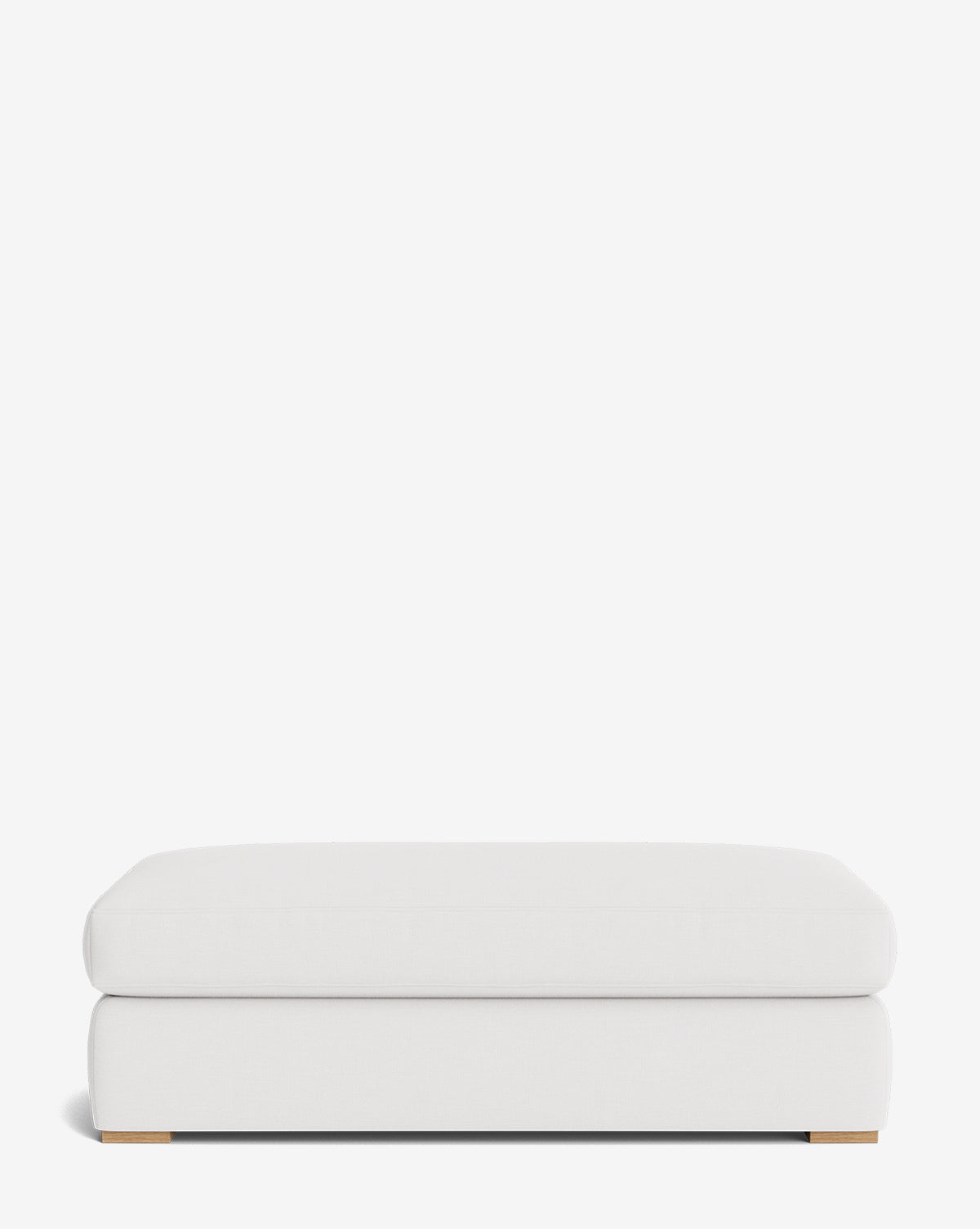 The Macy Upholstered Ottoman features a modern rectangular design with a cushioned top, minimalist look, and low wooden feet—perfect for any living room and shown against a plain white background, by McGee & Co.