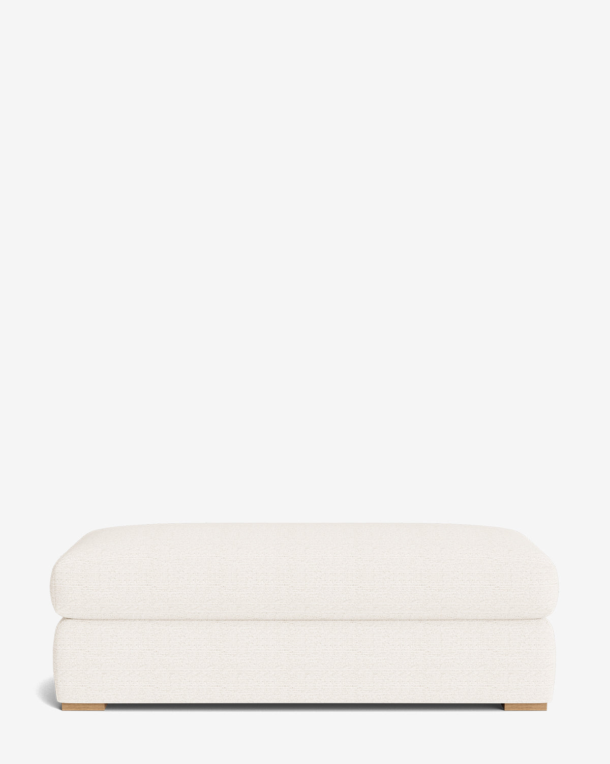 The Macy Upholstered Ottoman features a modern rectangular design, light cream fabric, and low wooden legs—ideal for living room furniture—shown against a plain white background by McGee & Co.