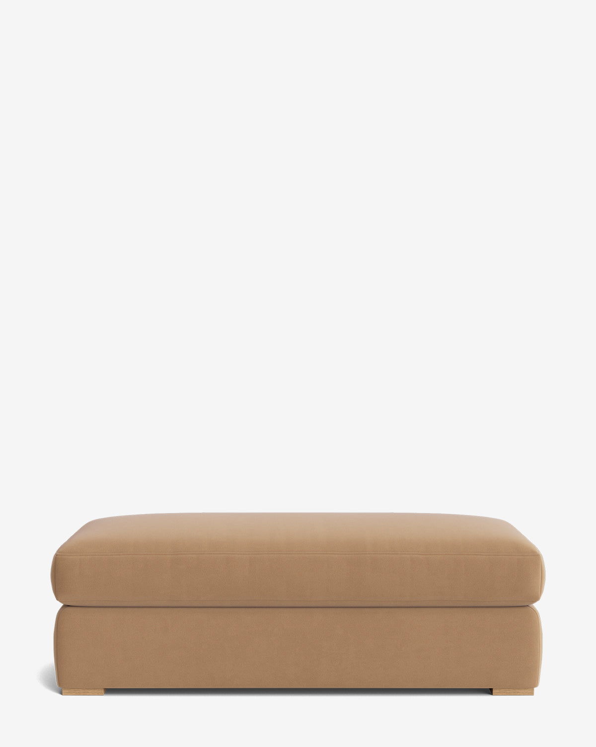 The Macy Upholstered Ottoman is a rectangular, low-profile piece in light brown fabric with a smooth surface and short square wooden feet—an elegant addition to your living room, shown here against a plain white background, by Vendixs