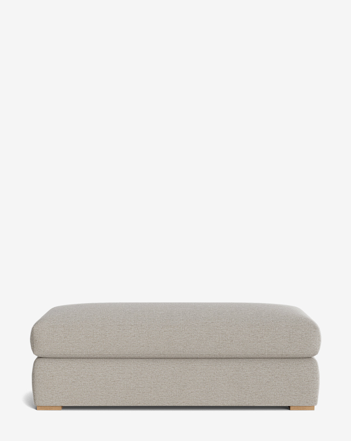 The Macy Upholstered Ottoman features a rectangular shape, light gray upholstery, modern design, and low wooden feet—ideal as customizable living room furniture—shown on a plain white background by McGee & Co.