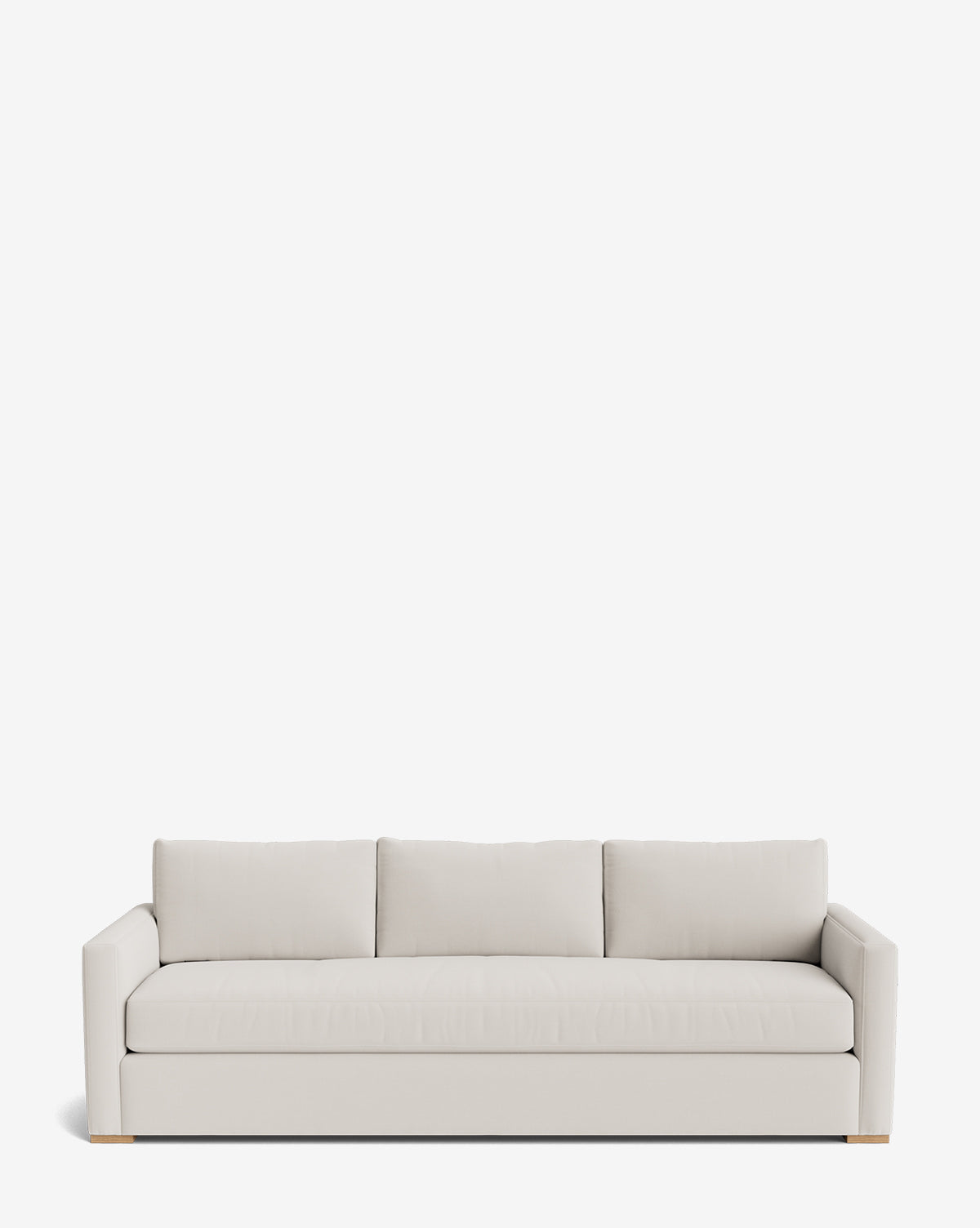 The Macy Upholstered Sofa (84-96) is a modern, light beige sofa with three seat and back cushions, clean straight arms, and wooden block feet. Its customizable, minimalist design makes it perfect living room furniture by Vendixs