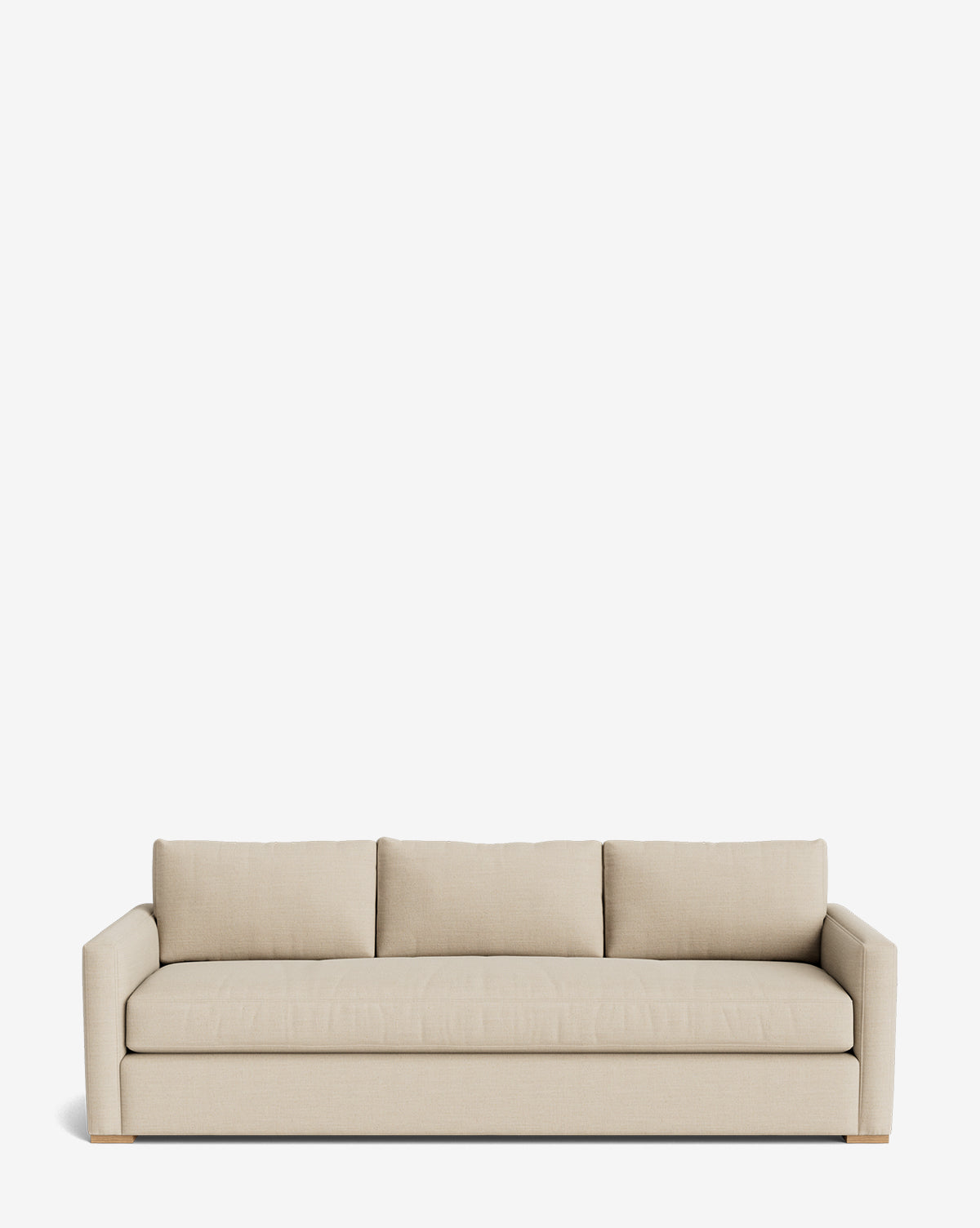 The Macy Upholstered Sofa (84-96) features modern beige upholstery, three seat and back cushions, low square arms, and wooden legs—an elegant living room piece shown against a plain white background, by Vendixs