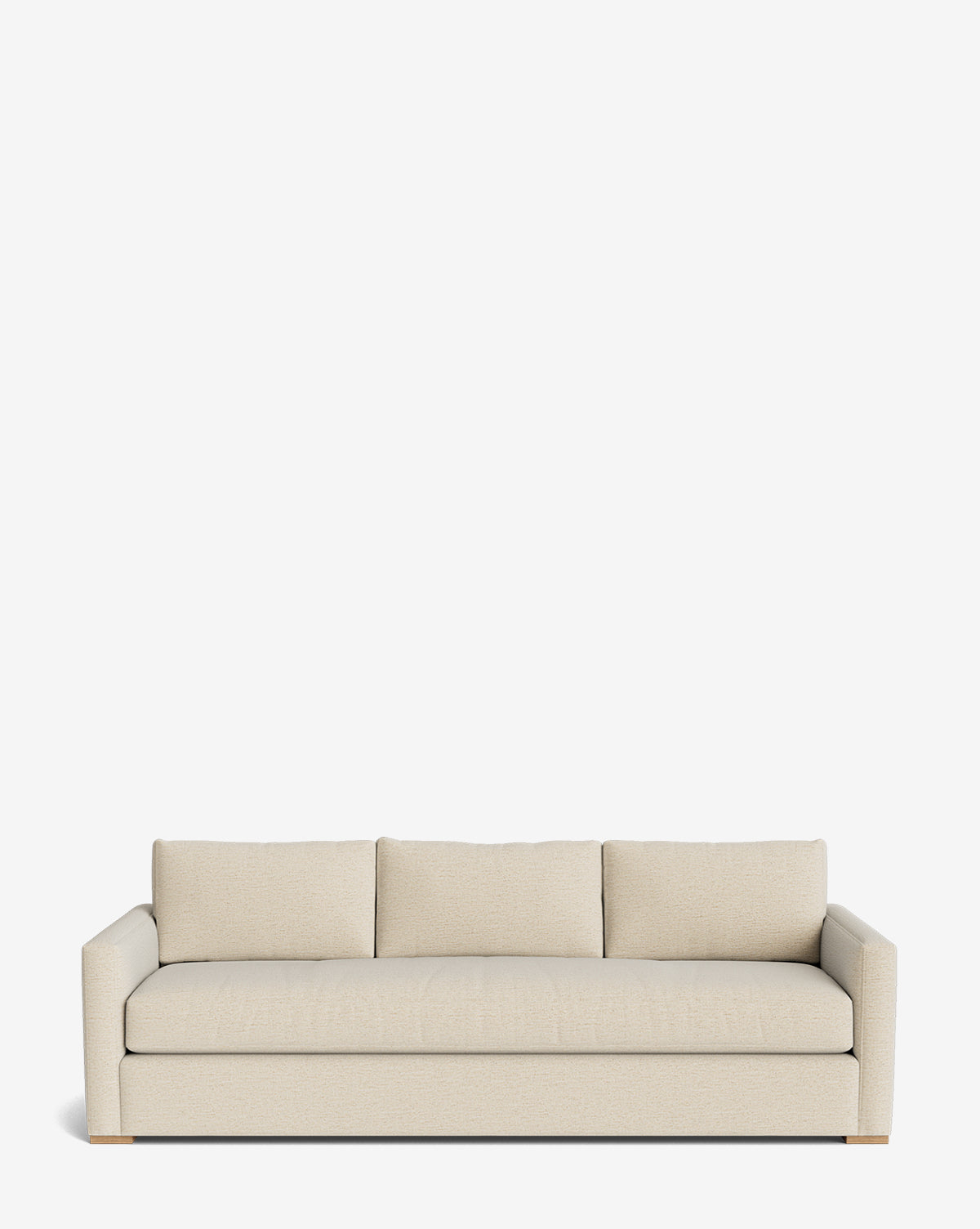 The Macy Upholstered Sofa (84-96) features a modern design in light beige, with three seat and back cushions, low arms, and wooden feet—an elegant living room addition shown against a plain white background, by Vendixs