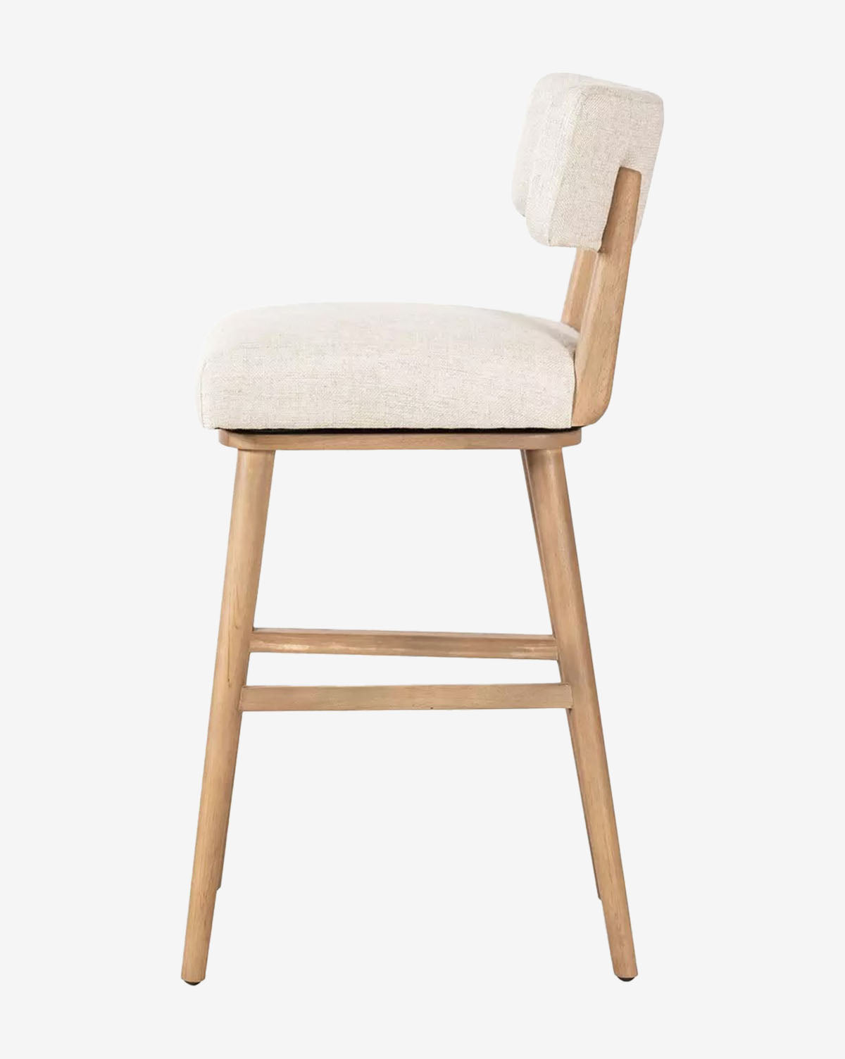 The Mance Swivel Stool by Four Hands features light wooden legs and an off-white cushioned upholstered seat and backrest, shown here from the side, available at Vendixs