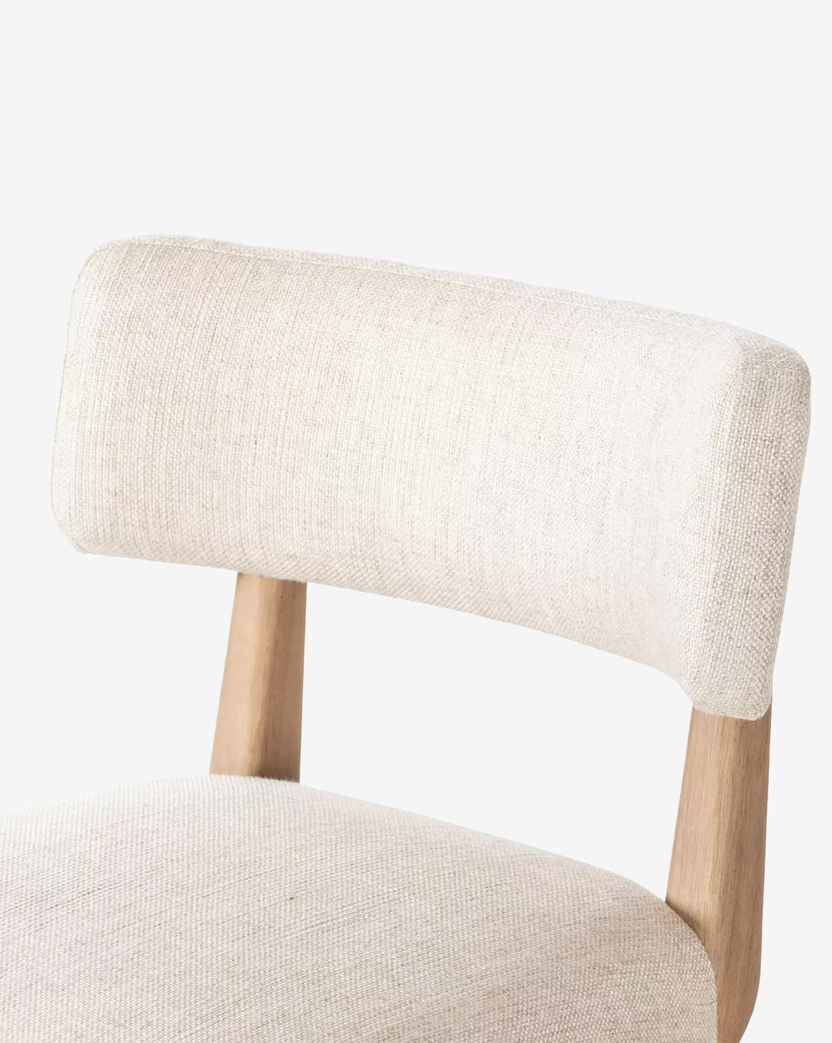 A close-up of the Mance Swivel Stool by Four Hands, featuring a light beige upholstered seat and backrest with wooden supports, set against a plain white background, Vendixs